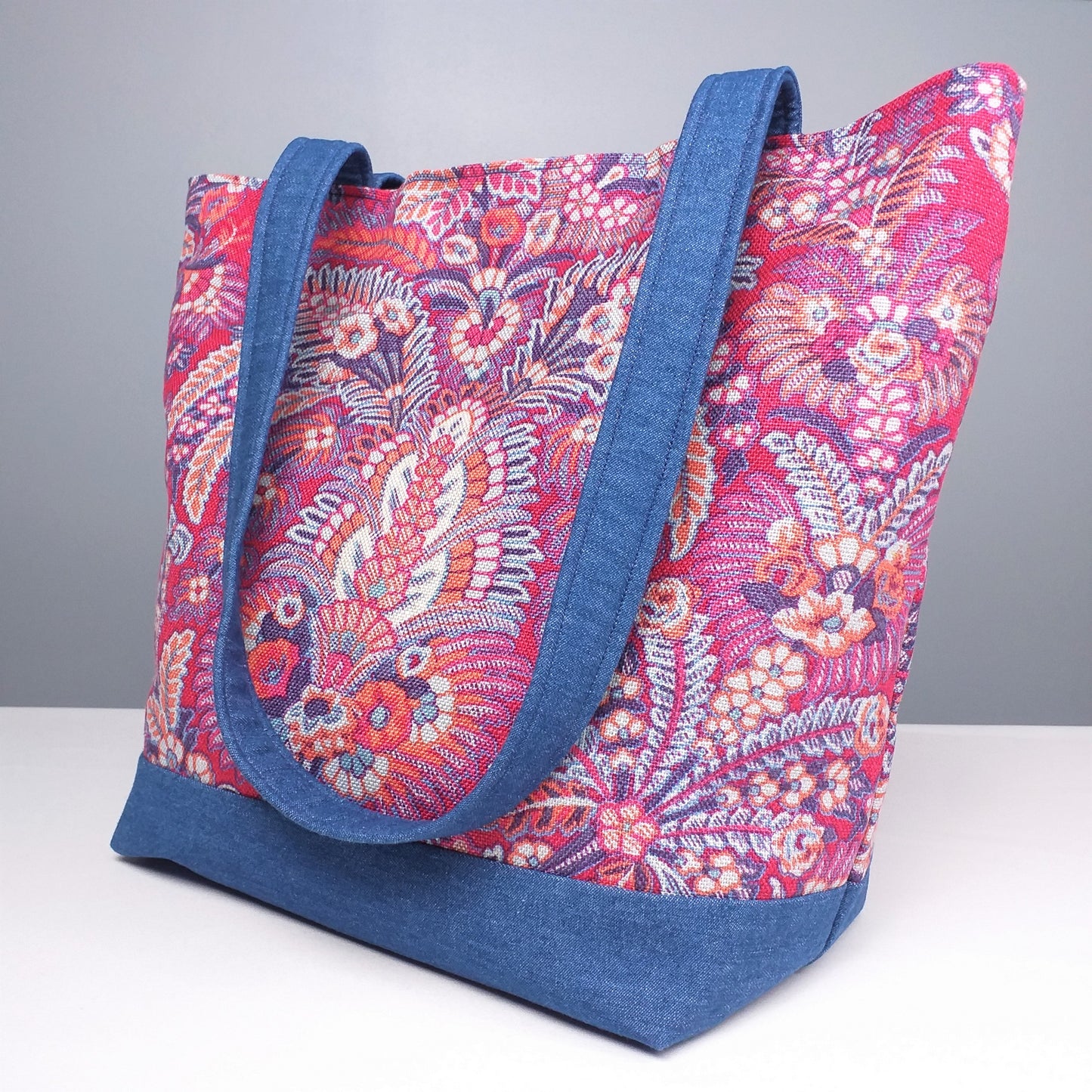 Large tote bag with multi-colour floral pattern, solid blue denim colour base