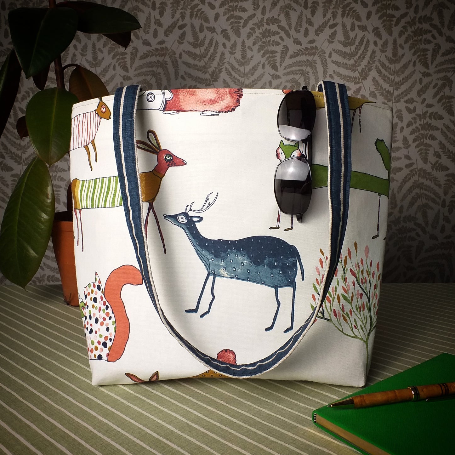 Large tote bag with multi-colour deer, foxes, squirrels, rabbits, and hedgehogs design on off-white background