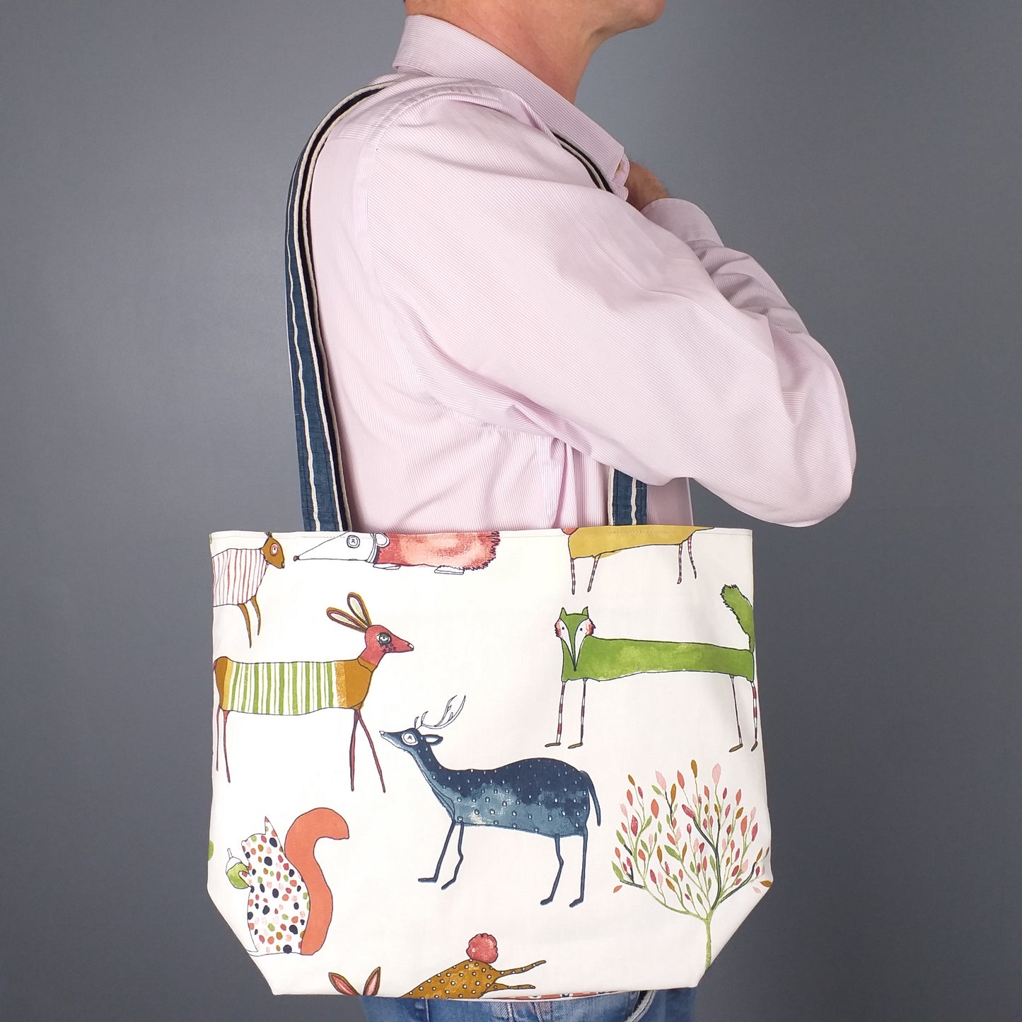 Large tote bag with multi-colour deer, foxes, squirrels, rabbits, and hedgehogs design on off-white background