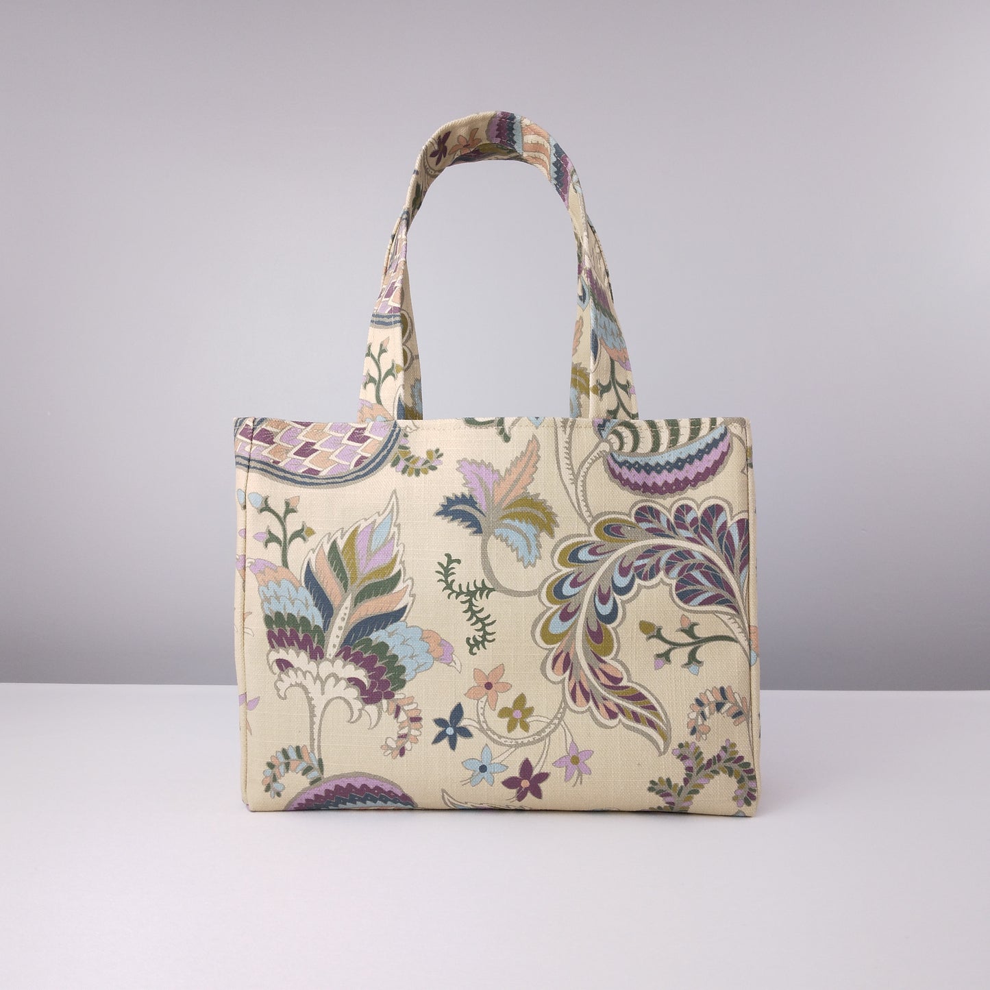 Mini tote bag with multi-colour floral print on beige background