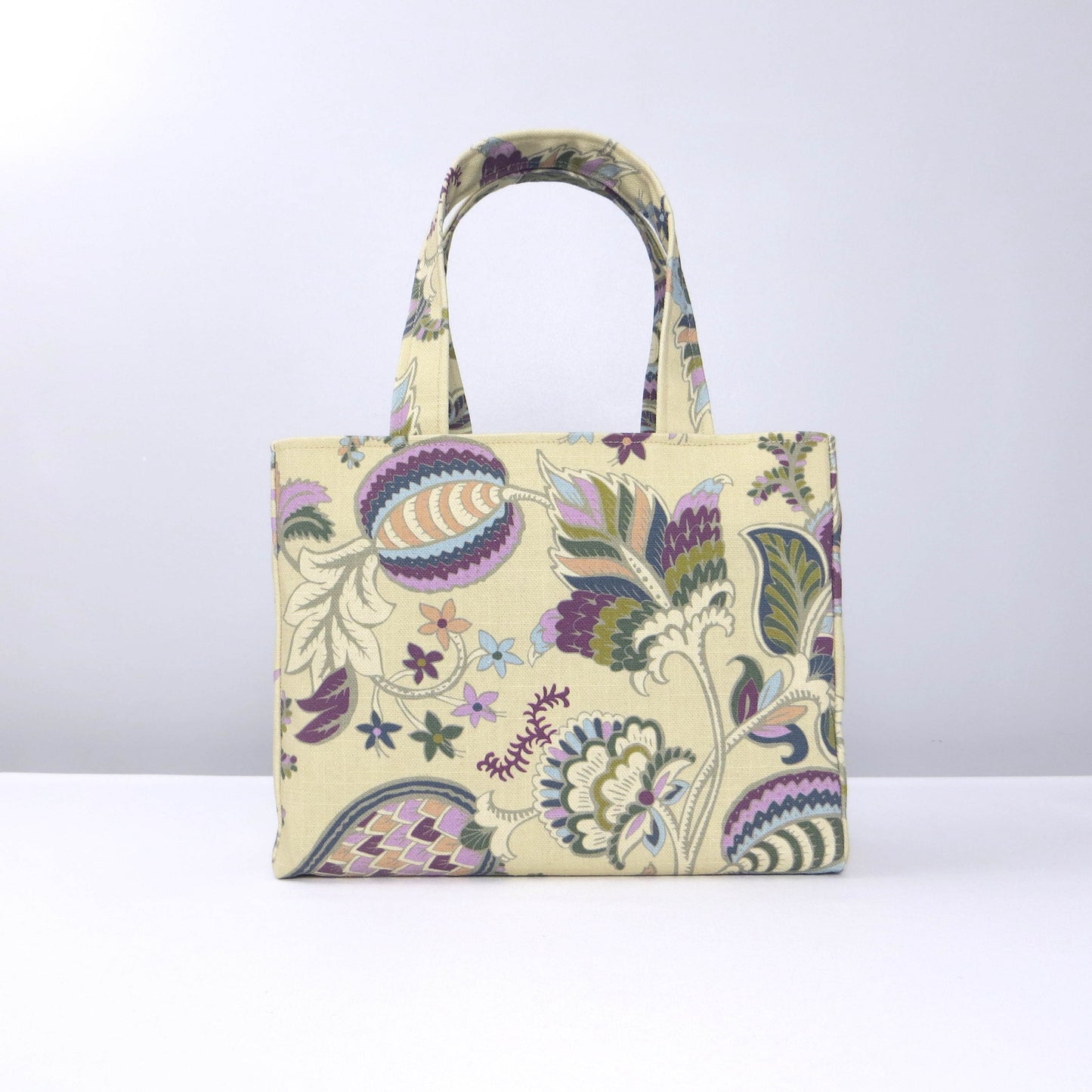 Mini tote bag with multi-colour floral print on beige background
