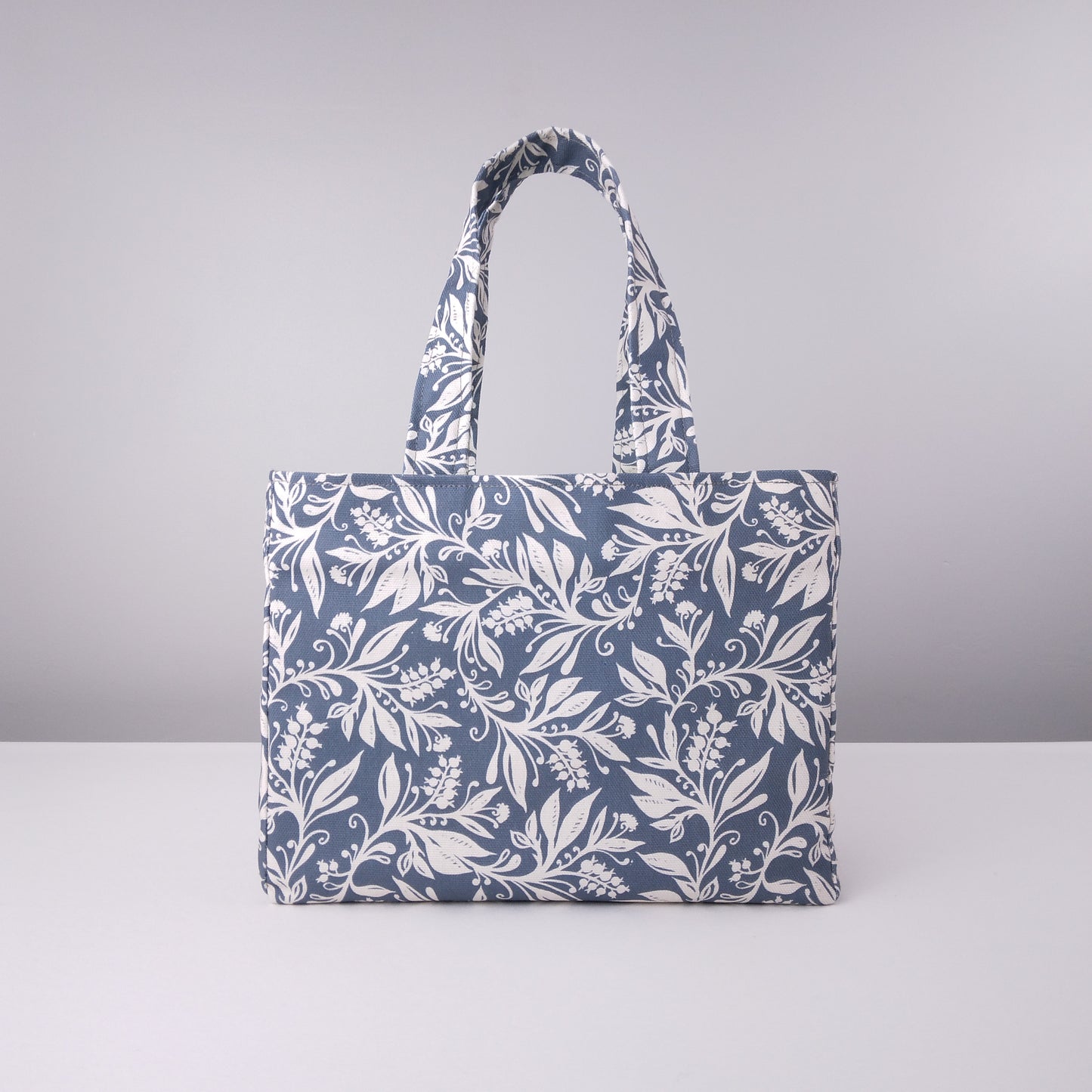Mini tote bag with white wildflower silhouette design on dark blue background