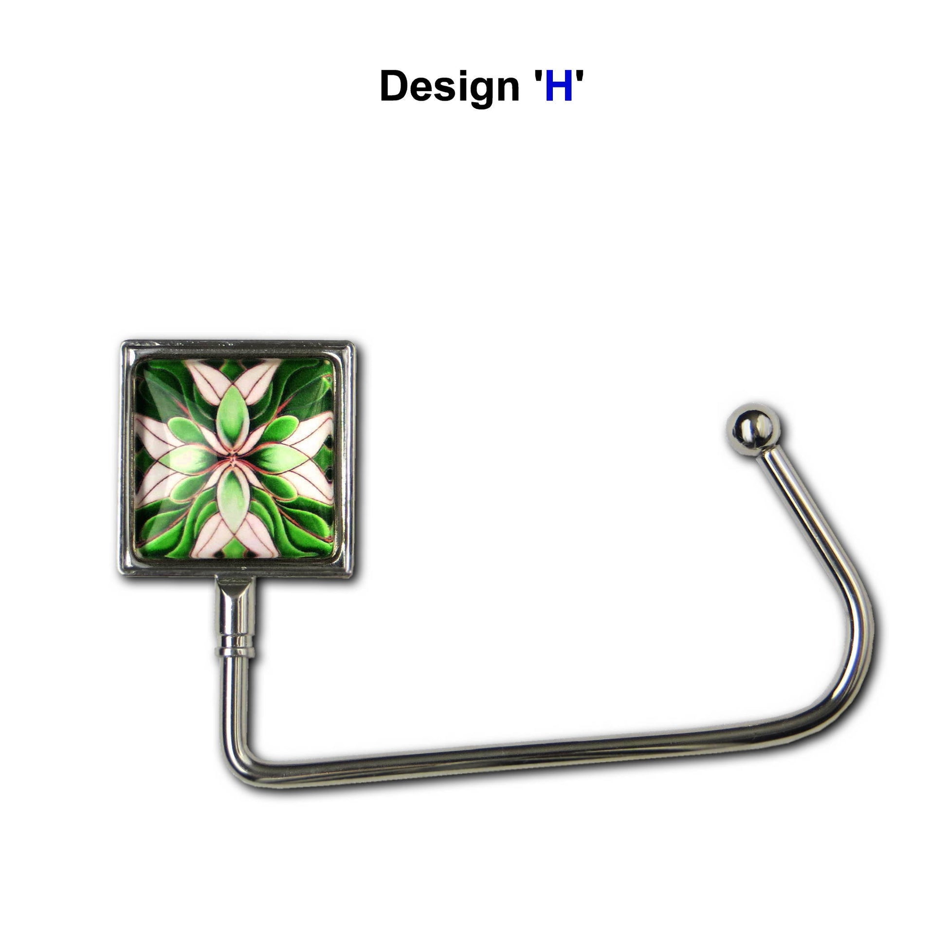 Handbag hook with glass domed image for hanging accessories on tables, ledges, and shelves