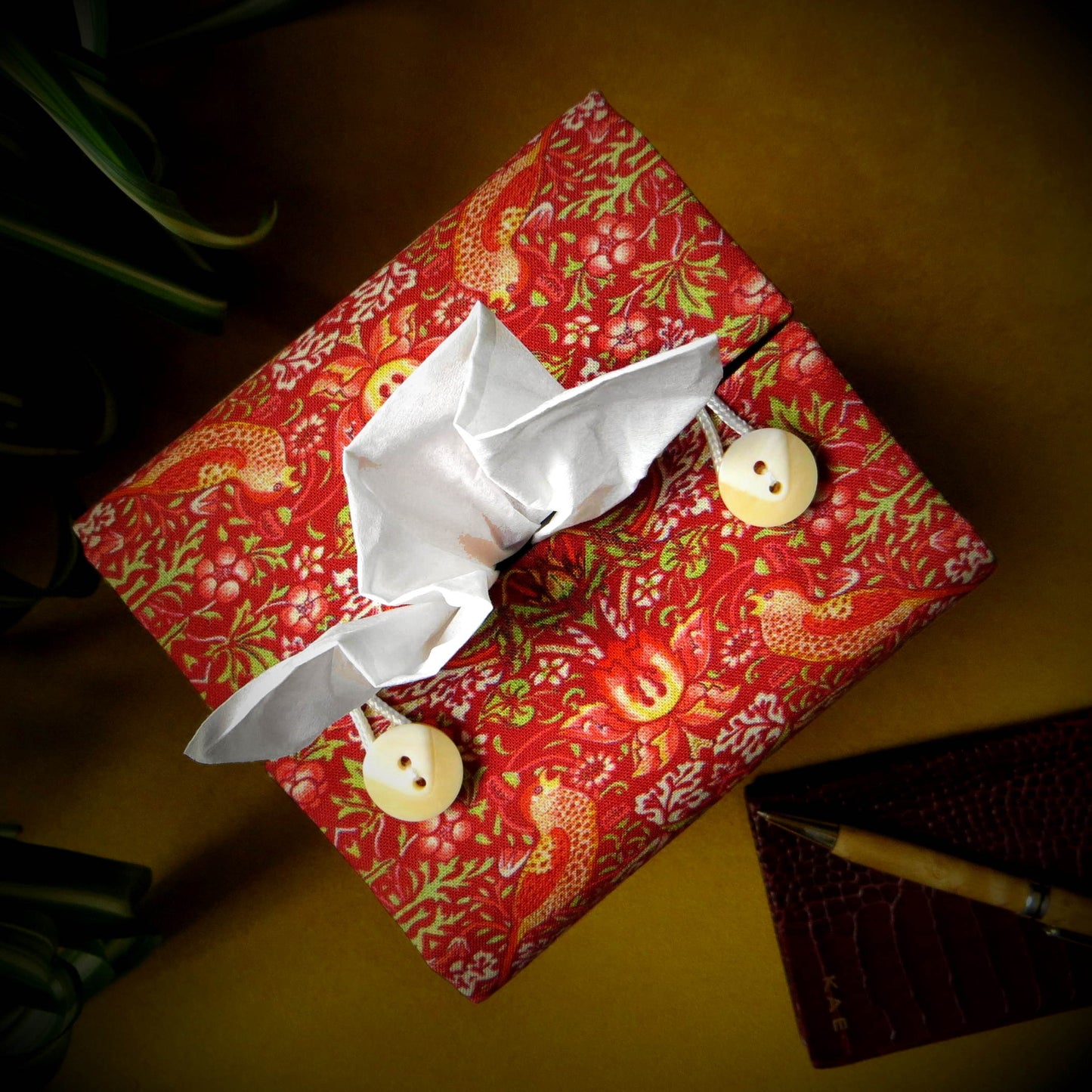 Square tissue box cover with birds and berries design on red background