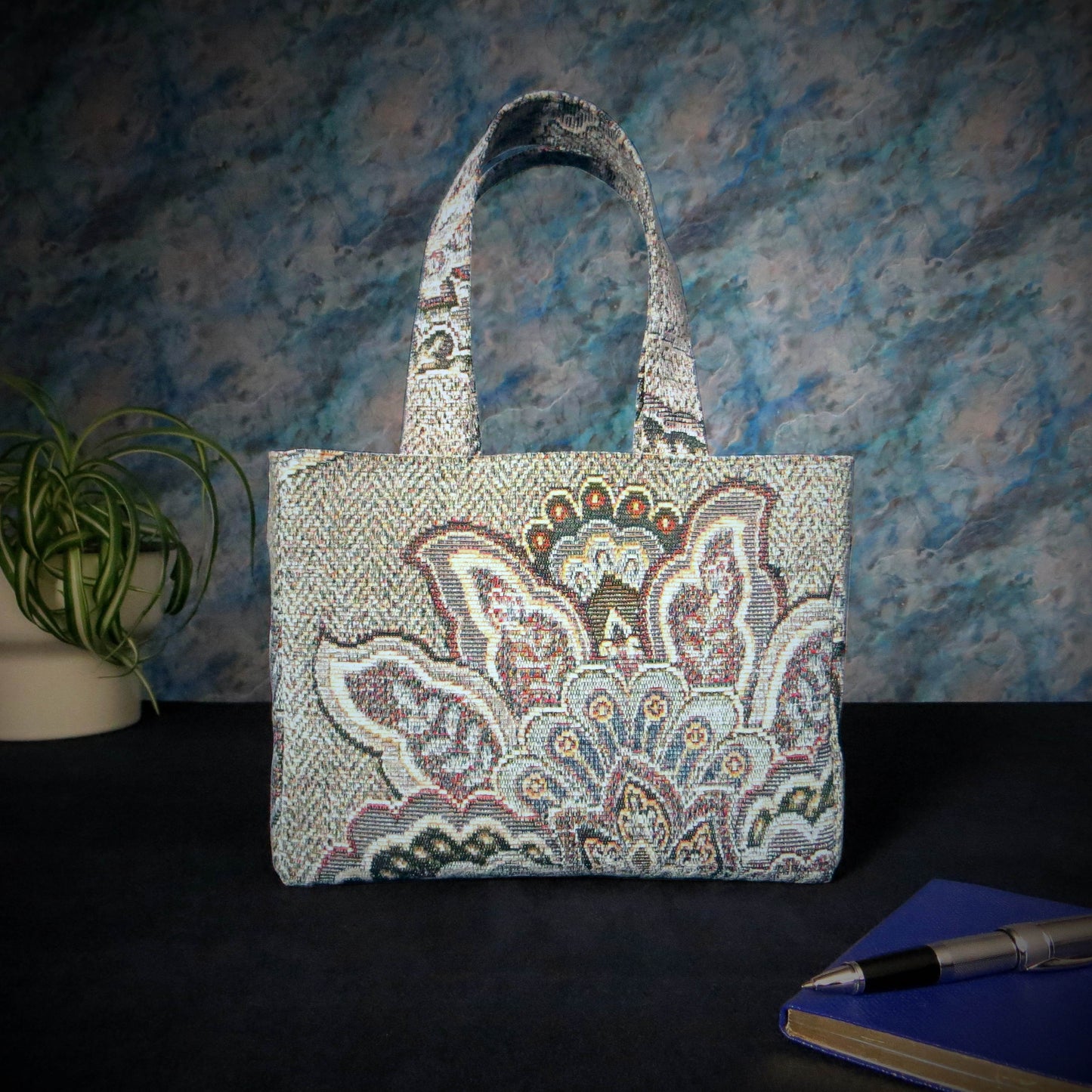 Mini tote bag with blue and grey floral design, and blue lining