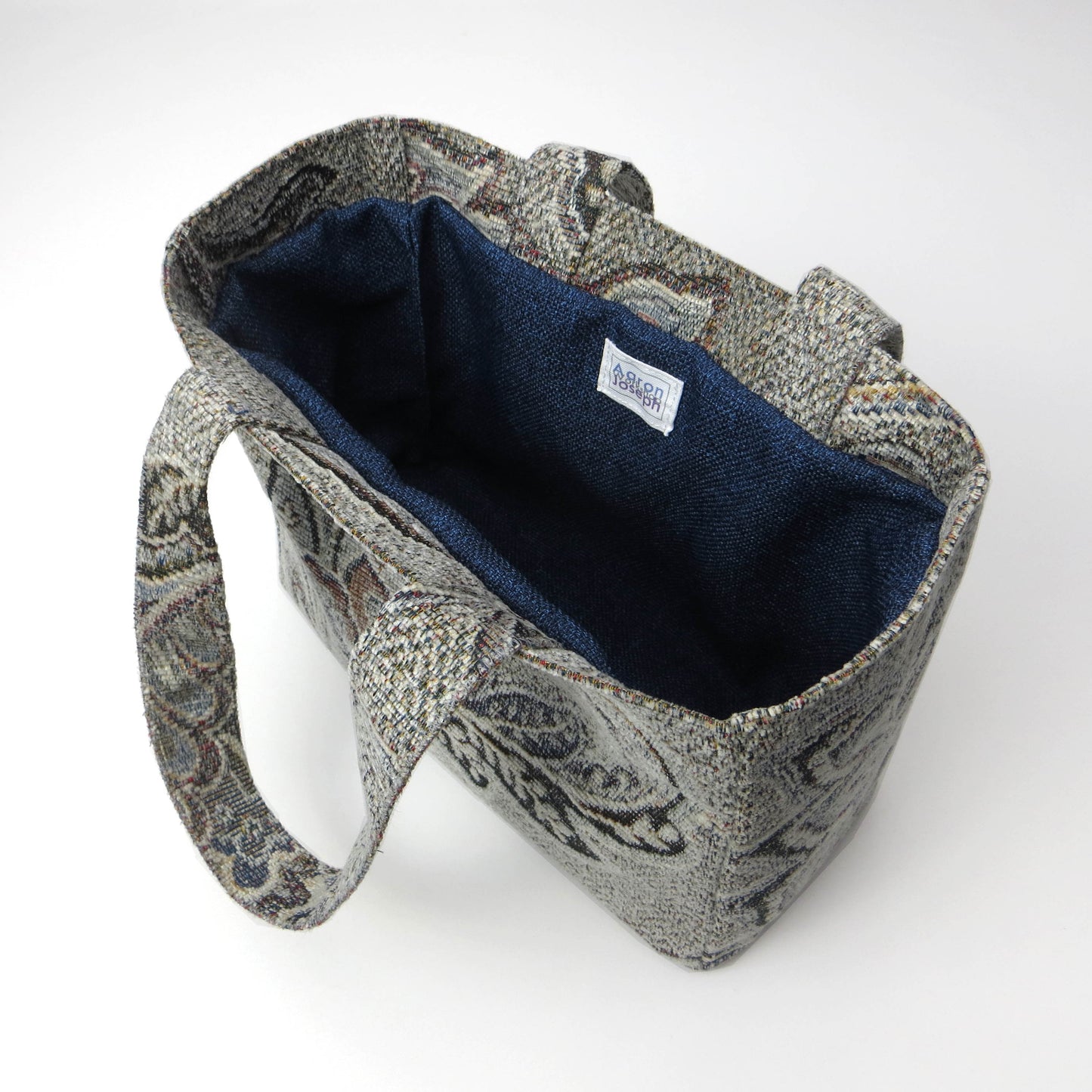 Mini tote bag with blue and grey floral design, and blue lining