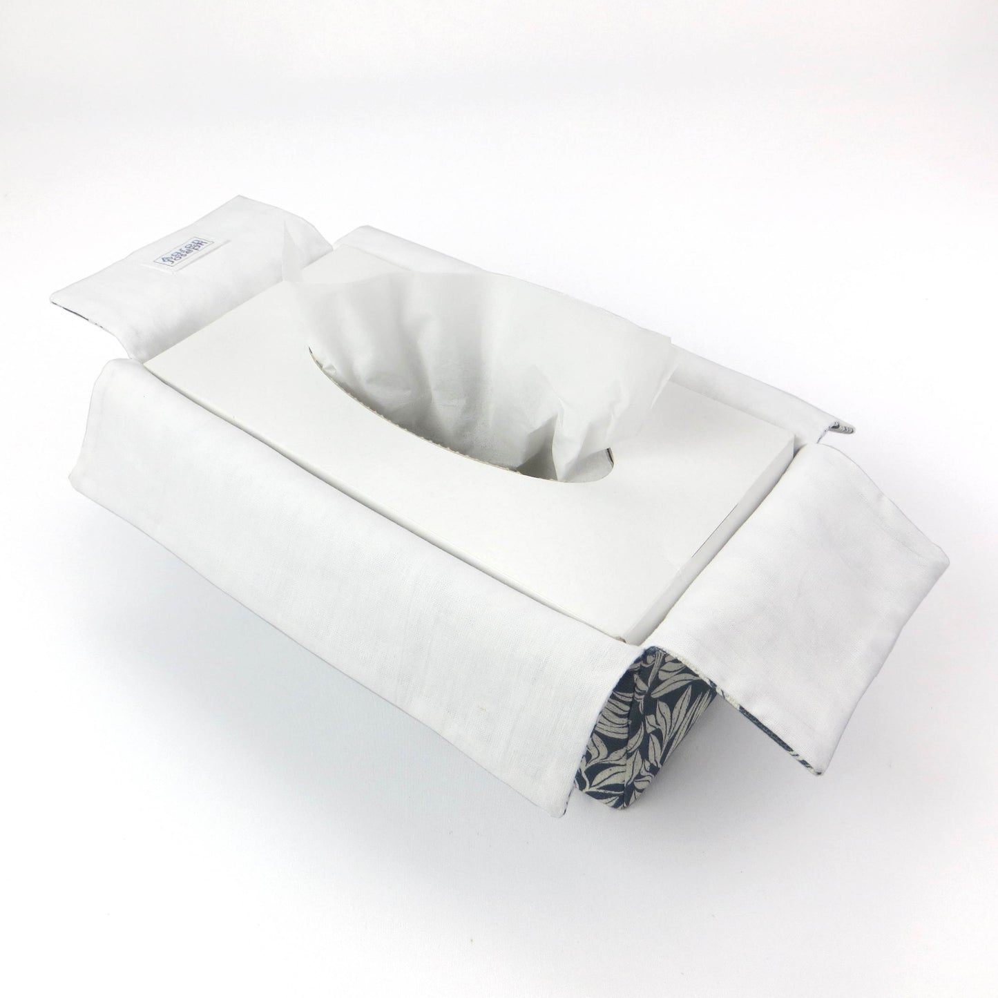 Linen rectangular tissue box cover with an off-white leaf pattern on a blue background