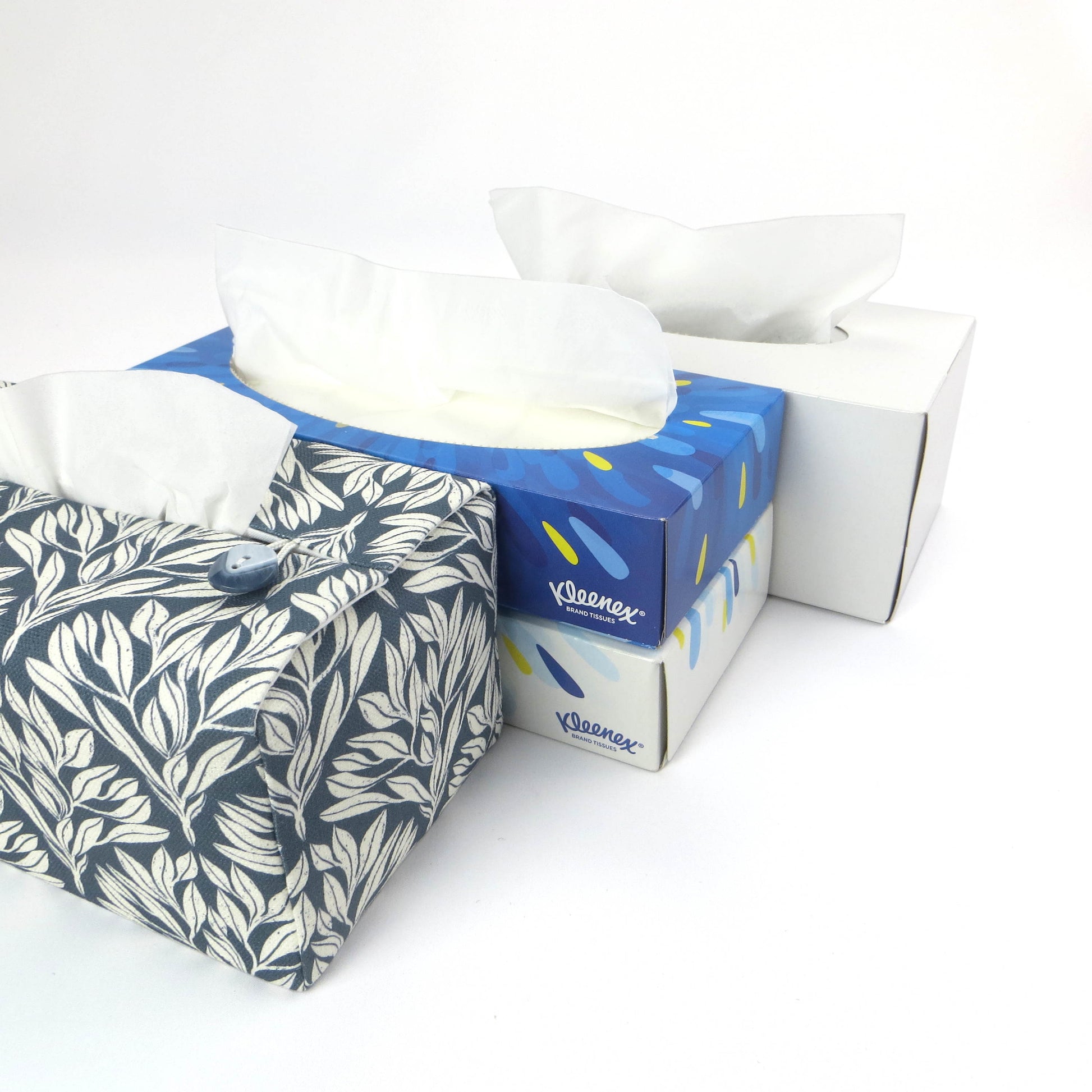 Linen rectangular tissue box cover with an off-white leaf pattern on a blue background