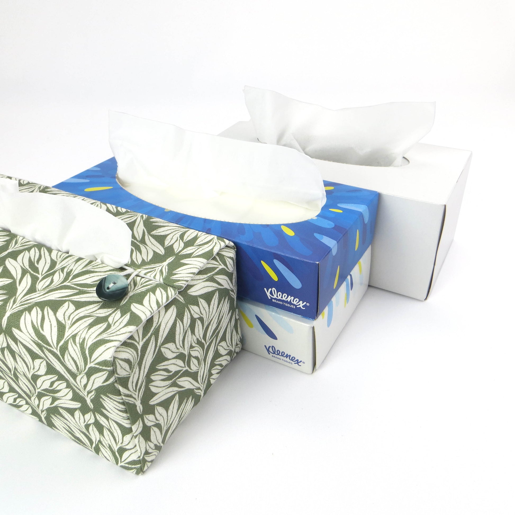 Linen rectangular tissue box cover with an off-white leaf pattern on a sage green background