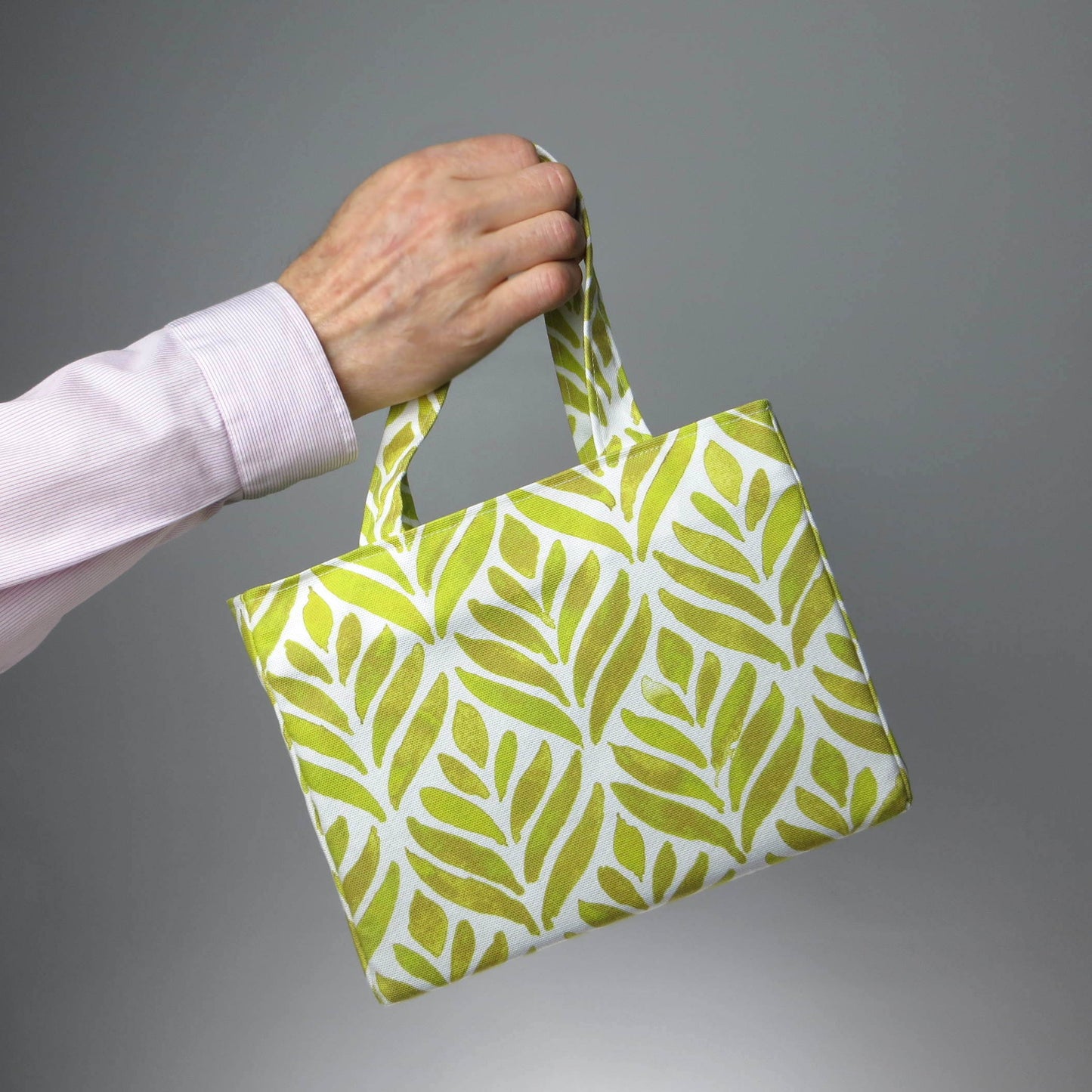 Mini tote bag with yellow watercolour style leaf pattern on background