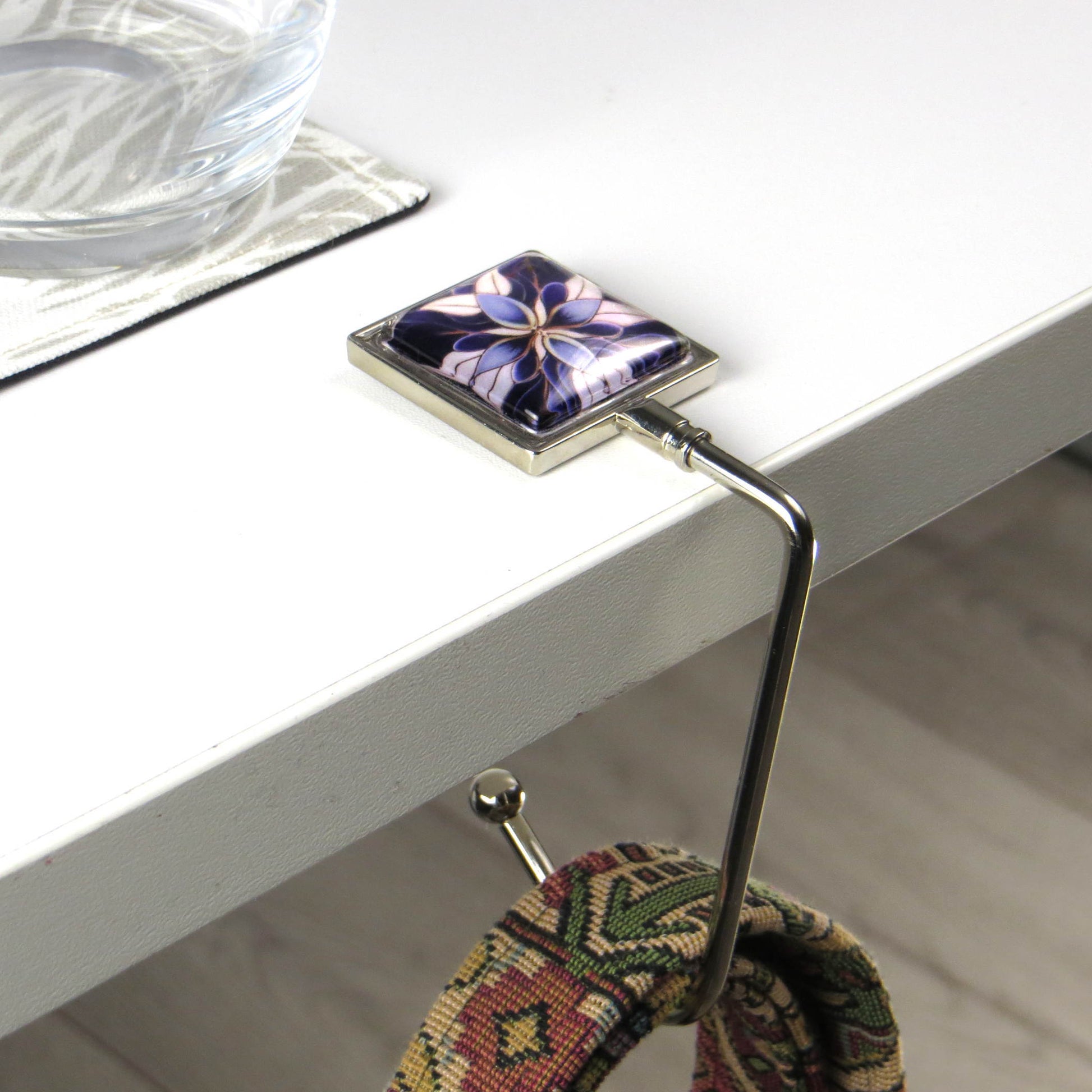 Handbag hook with glass domed image for hanging accessories on tables, ledges, and shelves