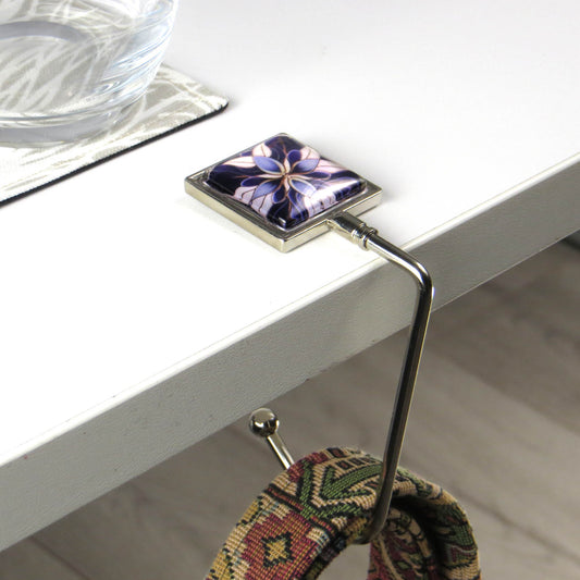 Handbag hook with glass domed image for hanging accessories on tables, ledges, and shelves