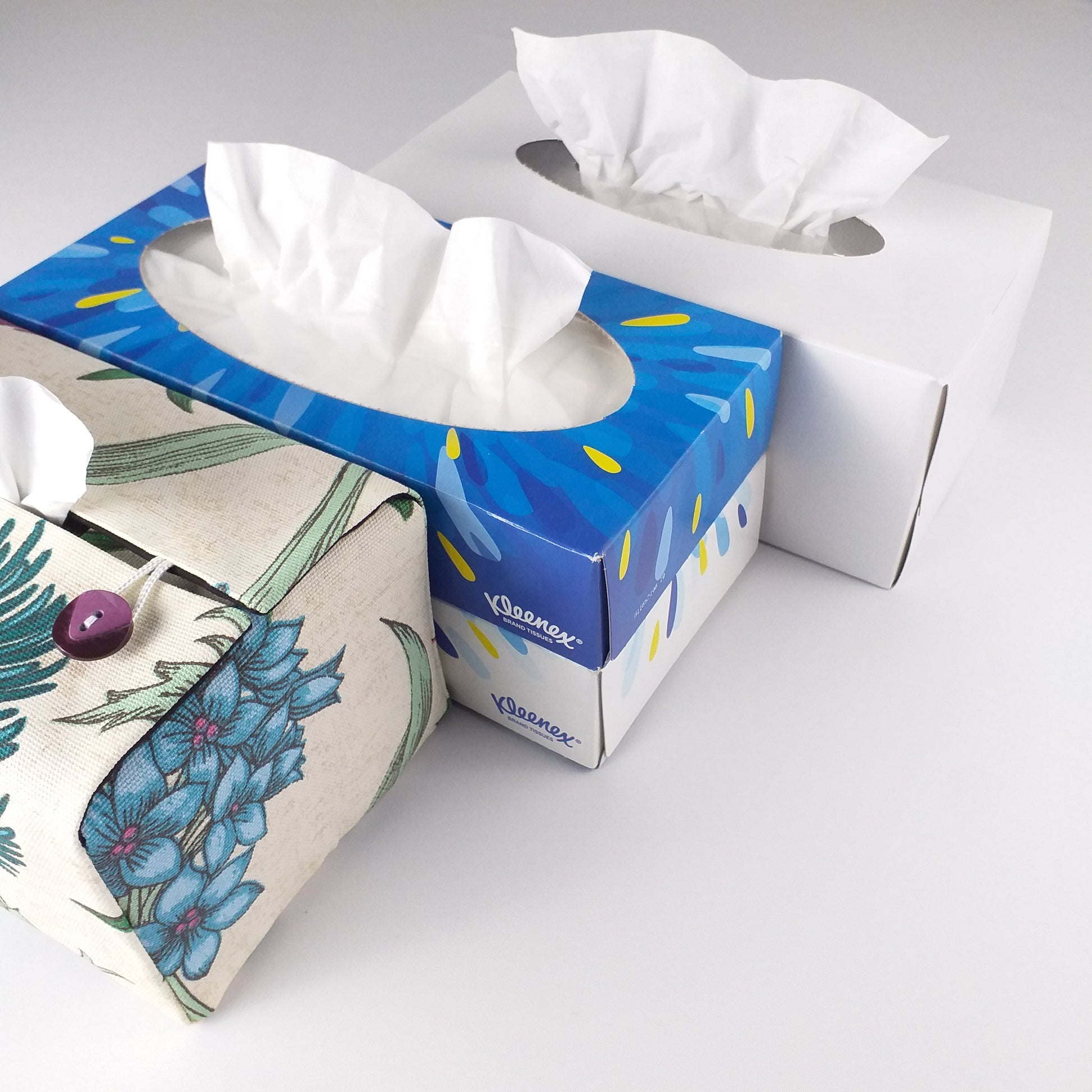 Rectangle tissue box cover with multi colour large botanical design on off-white background