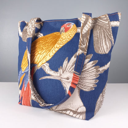 Large tote bag with grey birds and colour parrot design on blue background