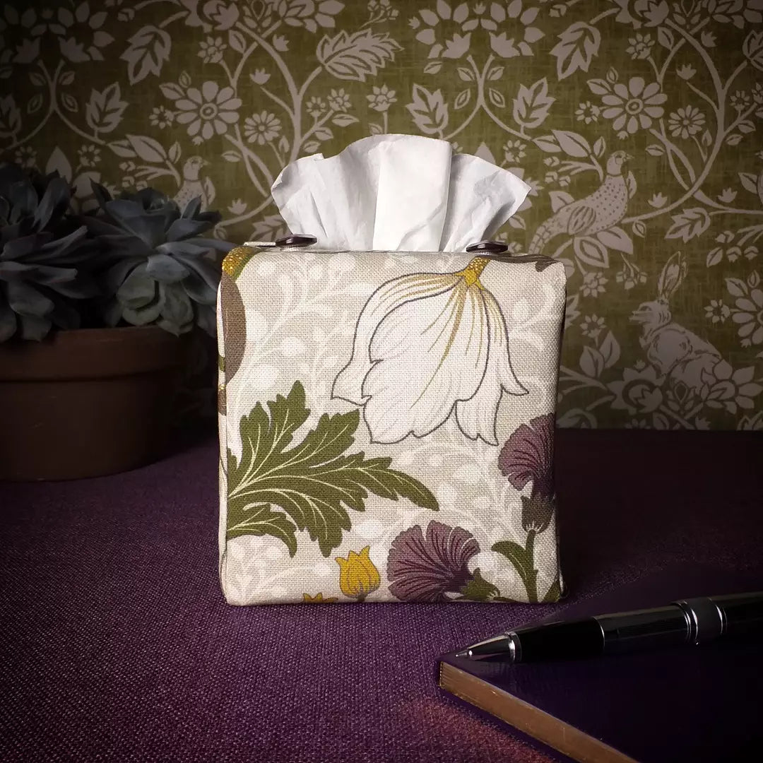 Square tissue box cover with white magnolia flowers design with green, yellow, and purple accents
