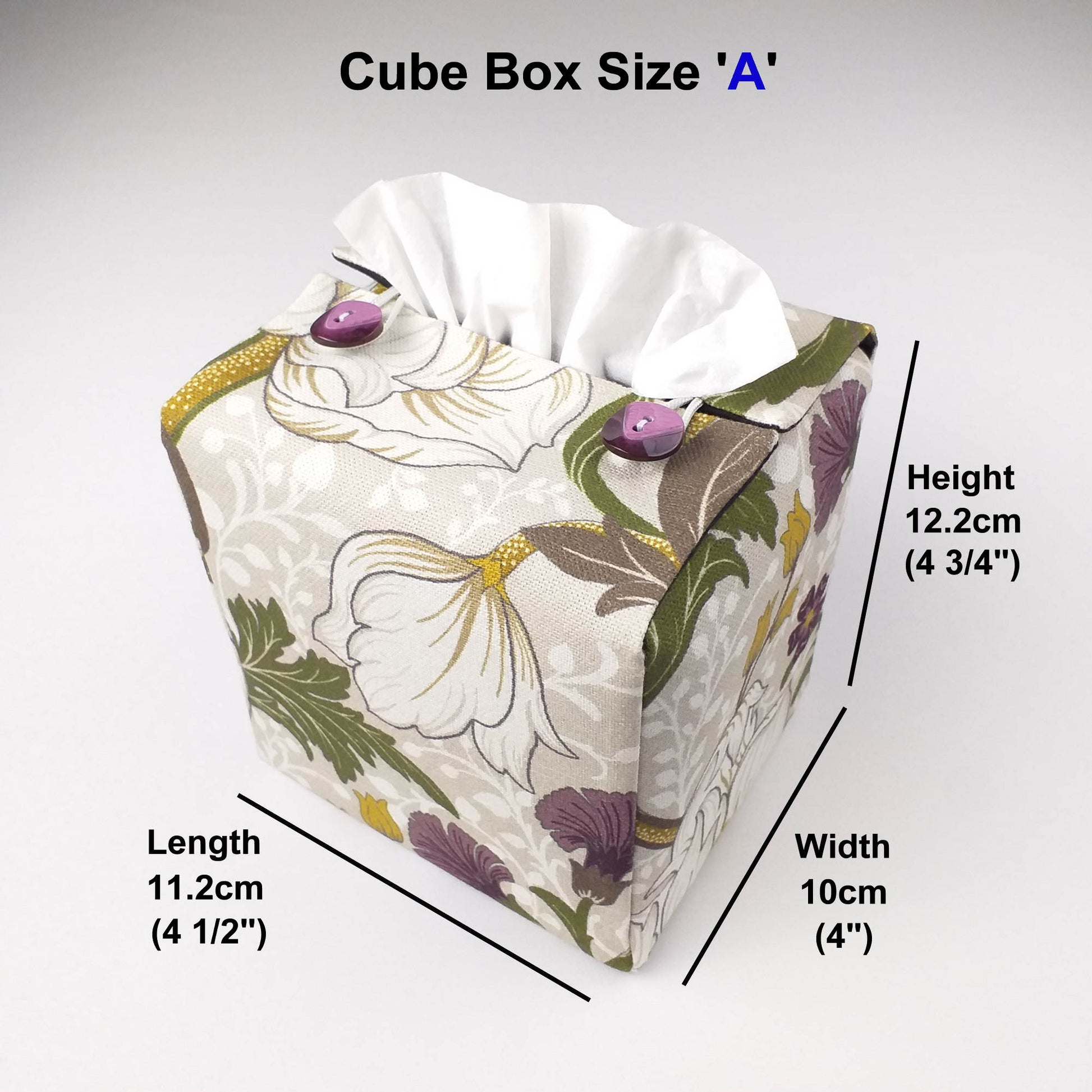 Square tissue box cover with white magnolia flowers design with green, yellow, and purple accents