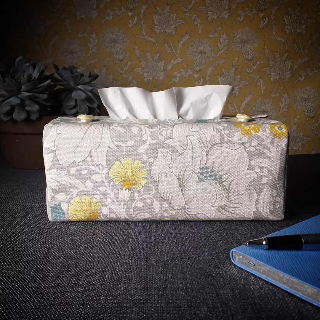 Rectangle tissue box cover with white magnolia flowers design with blue, yellow, and grey accents
