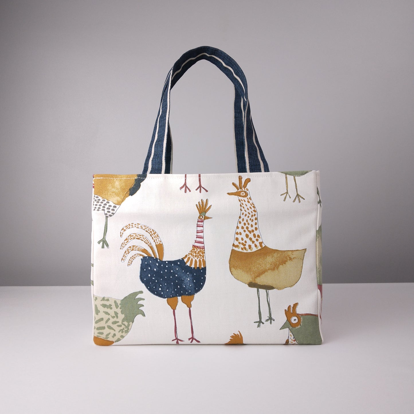 Mini tote bag with multi-colour hens design on beige background