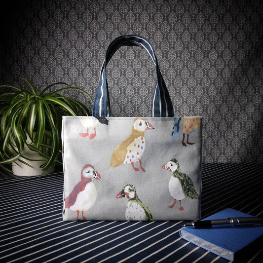 Mini tote bag with multi-colour puffins design on grey background