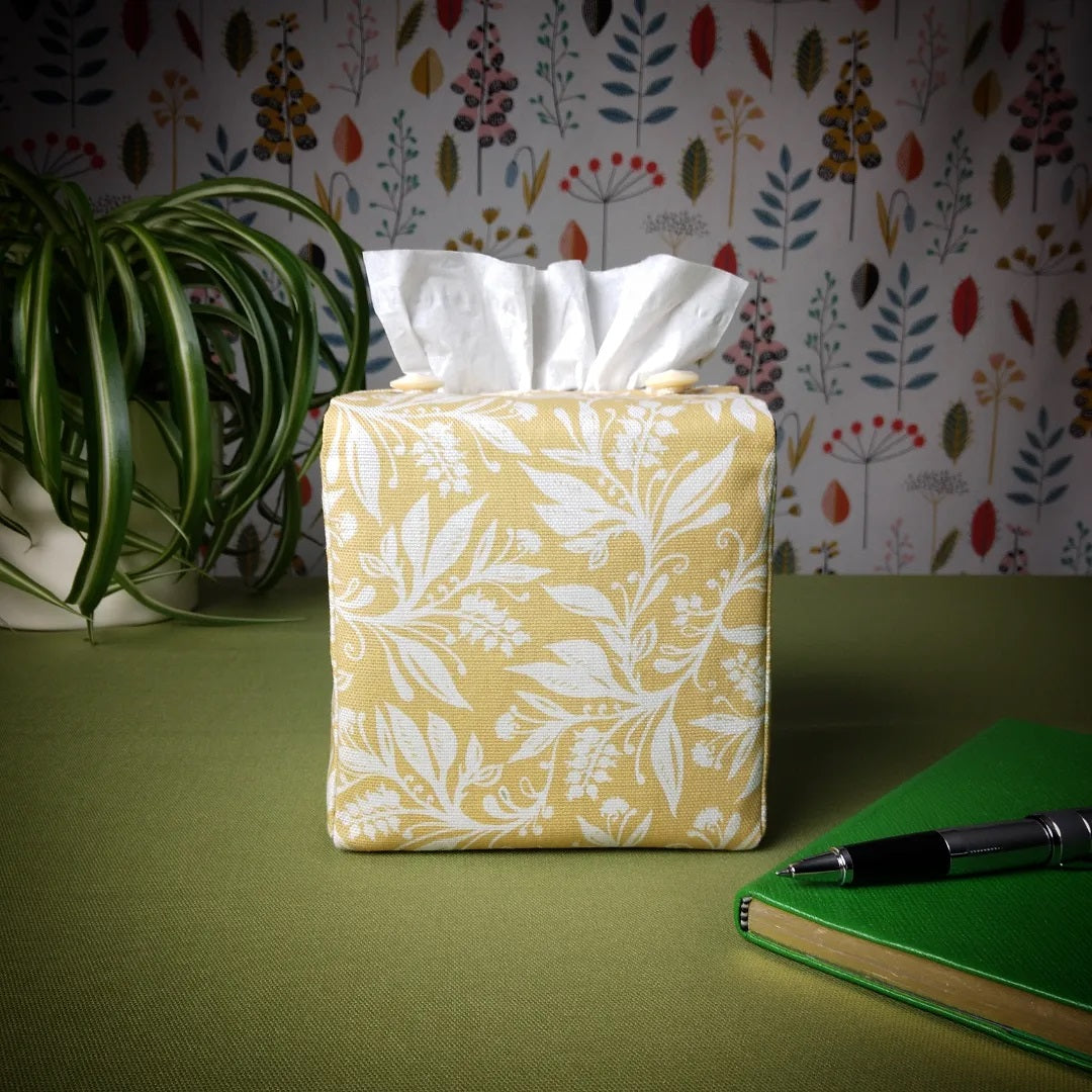 Square tissue box cover with white wildflower pattern on yellow background