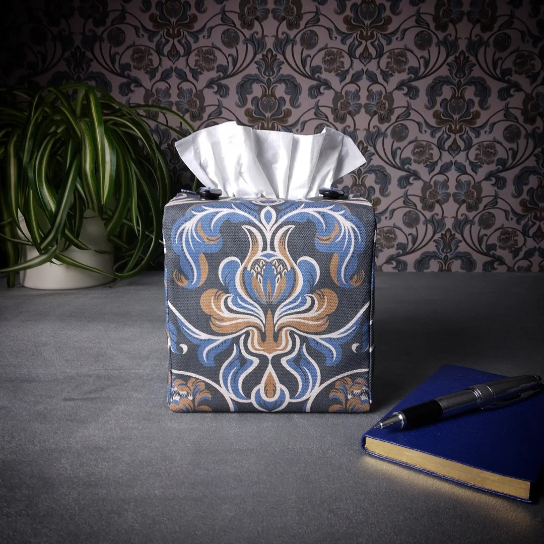 Square tissue box cover with white, brown, and blue baroque style floral design on navy background