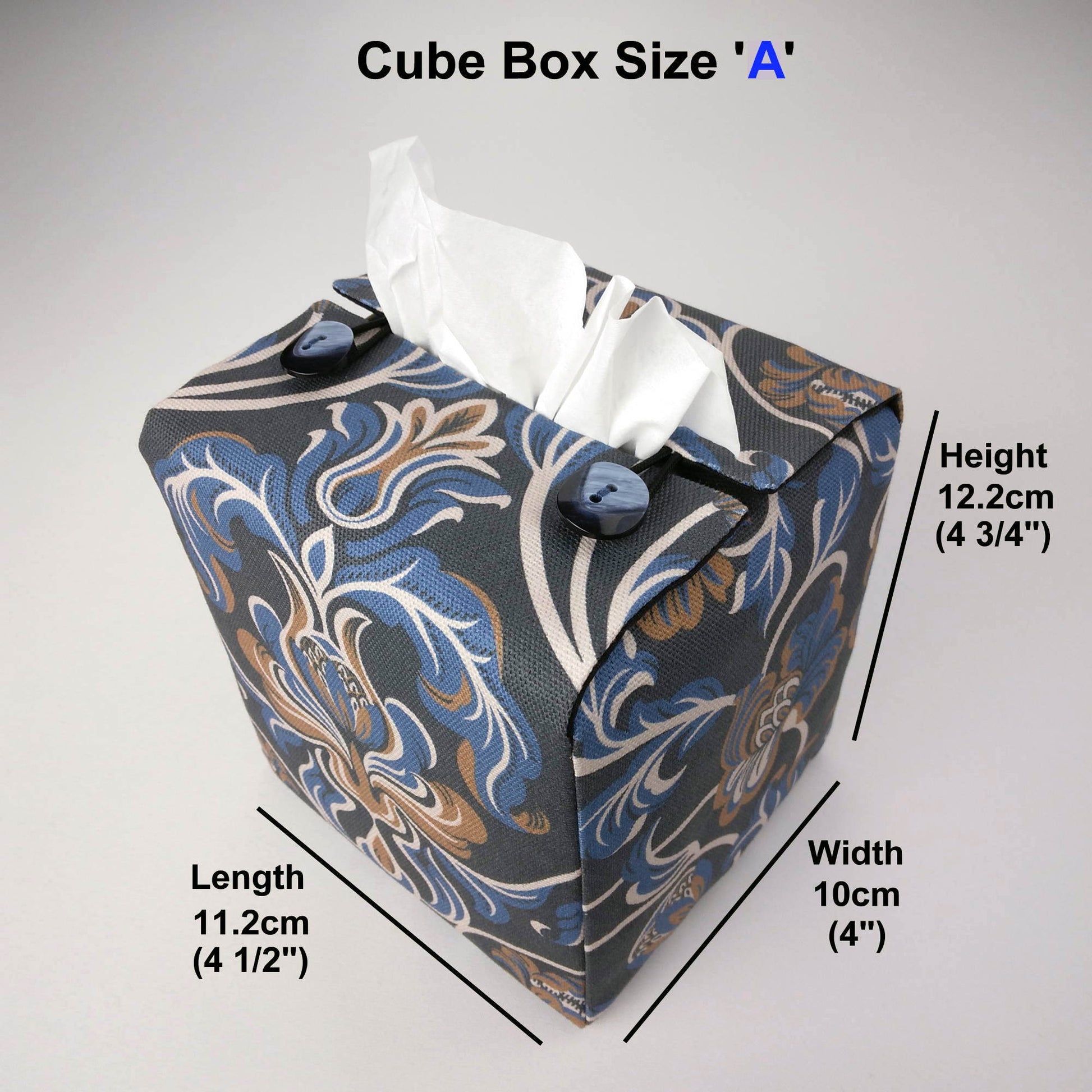 Square tissue box cover with white, brown, and blue baroque style floral design on navy background