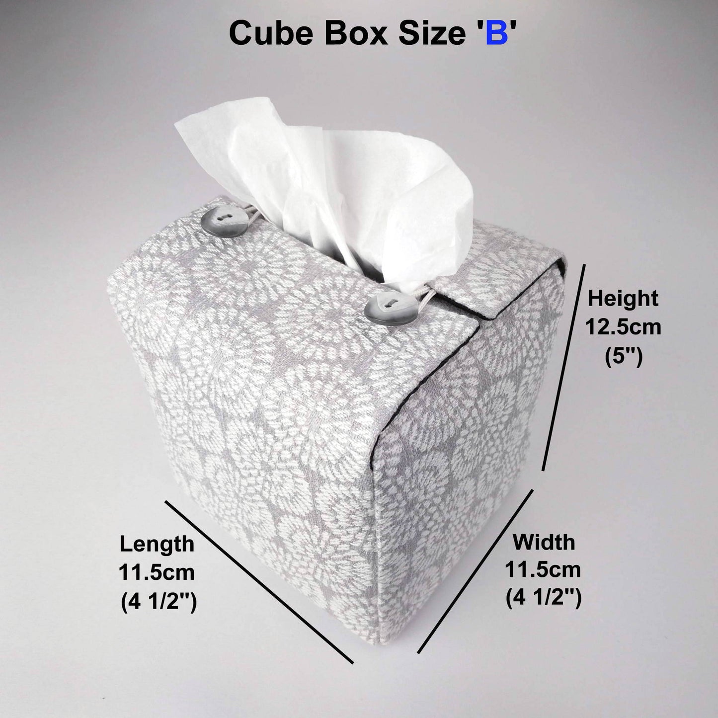Square tissue box cover with white retro daisy design on light grey background