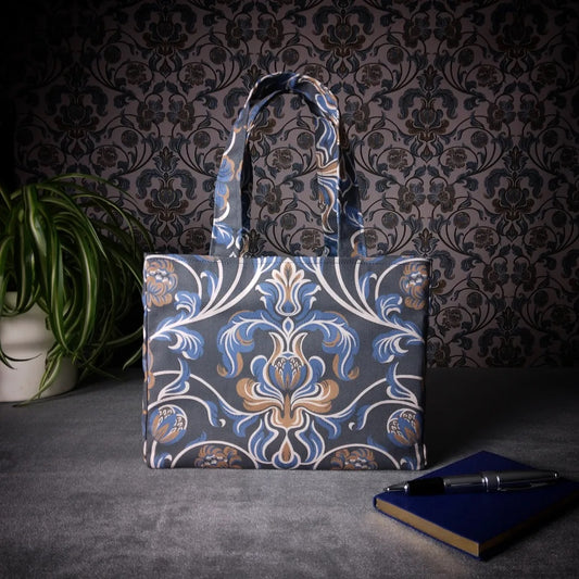 Mini tote bag with white, brown, and blue baroque style floral design on navy background