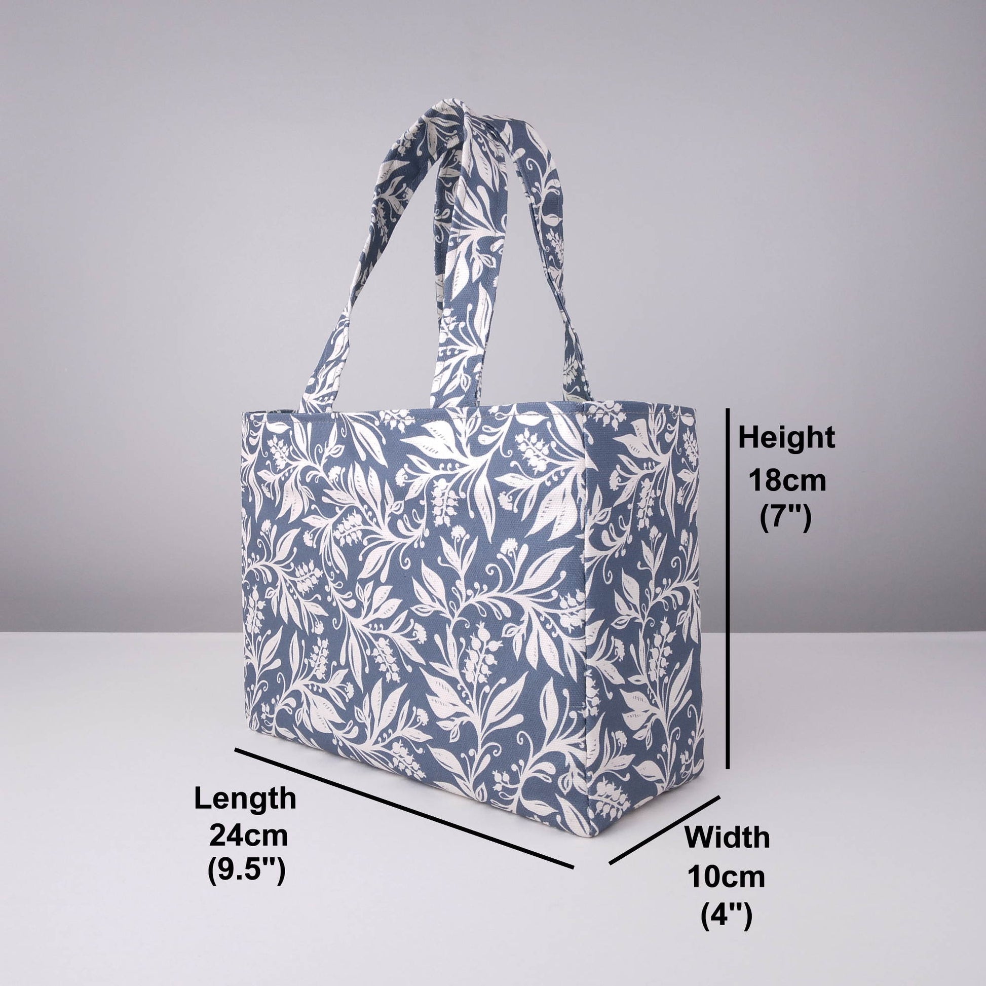 Mini tote bag with white wildflower silhouette design on dark blue background
