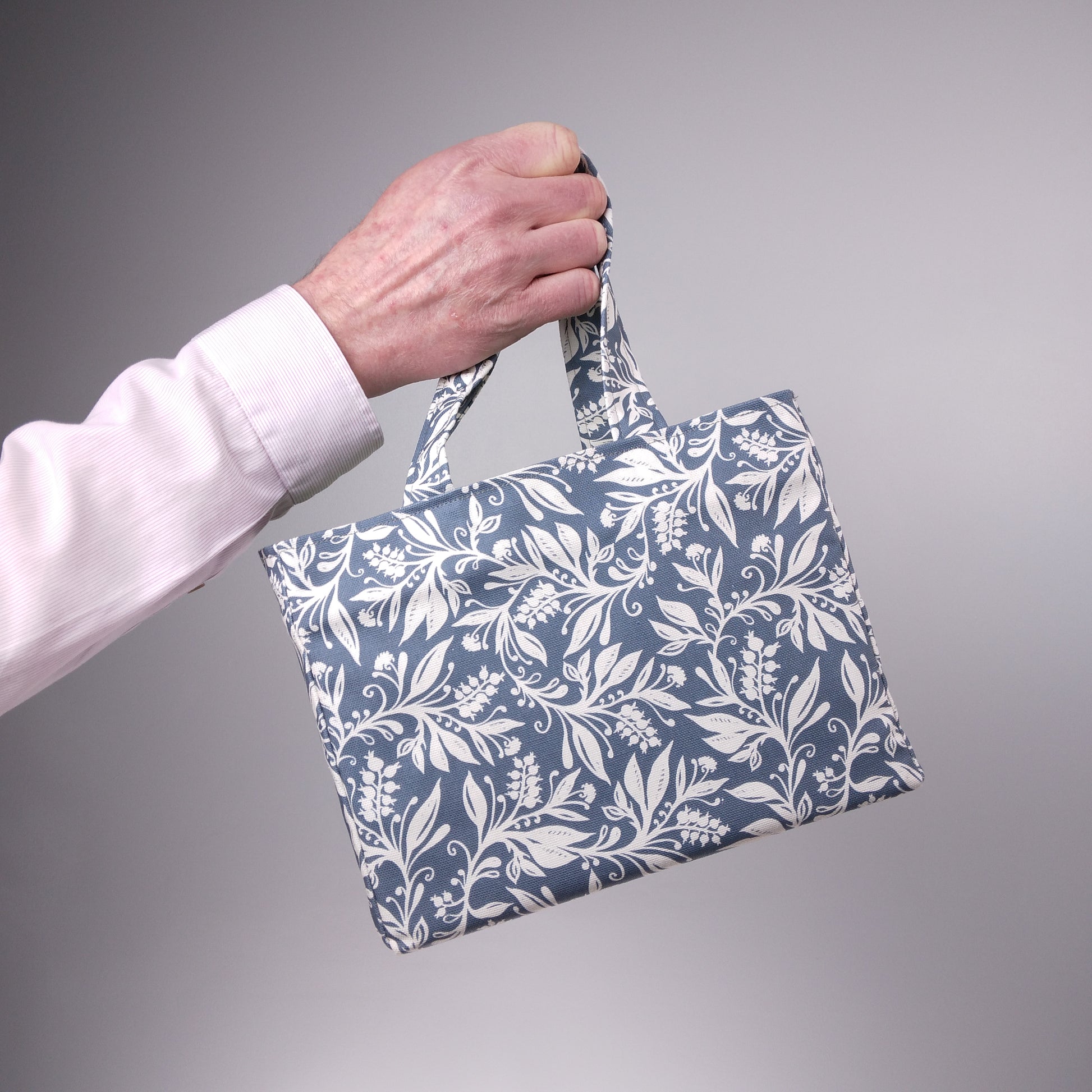 Mini tote bag with white wildflower silhouette design on dark blue background