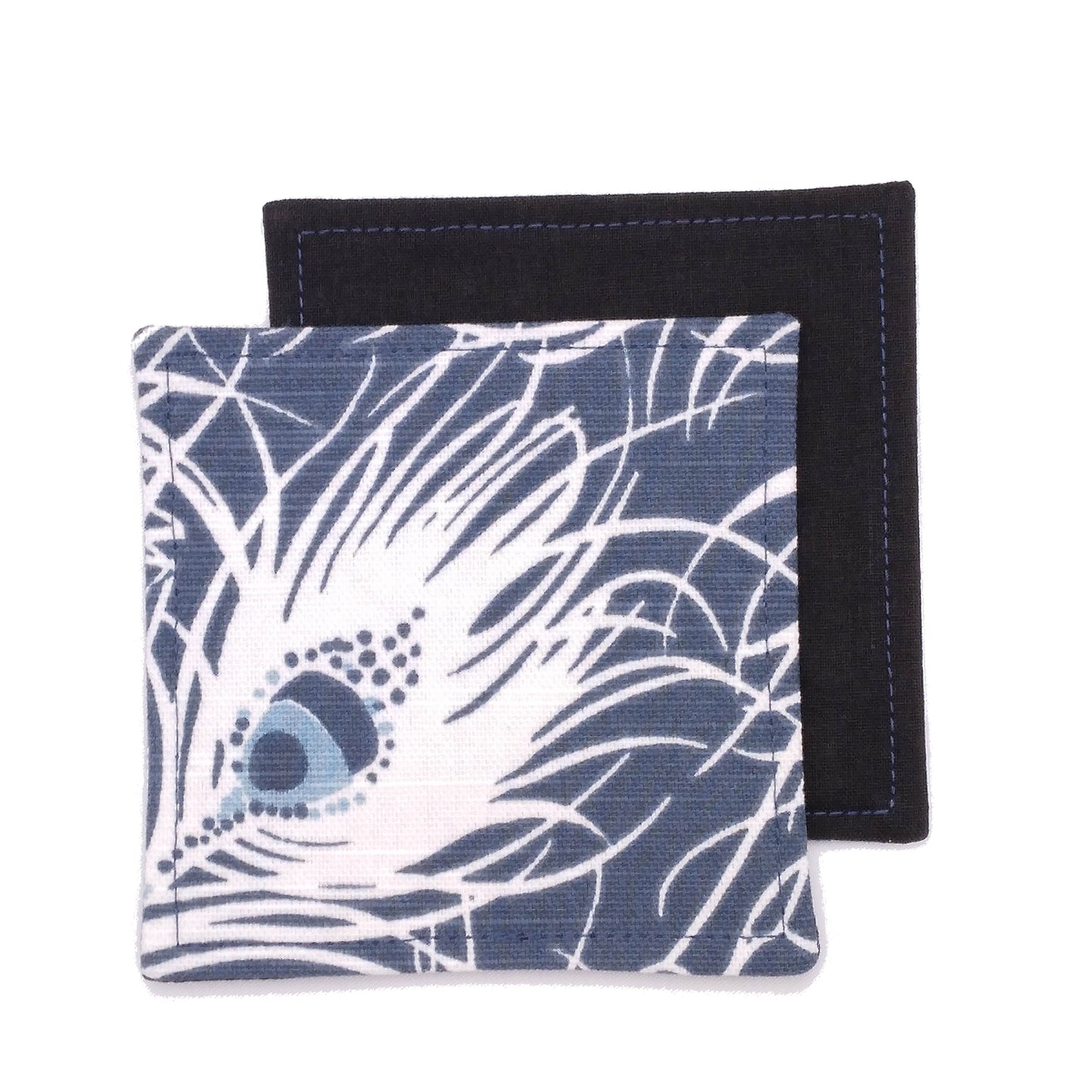 Square coasters with white peacock feathers design on blue background