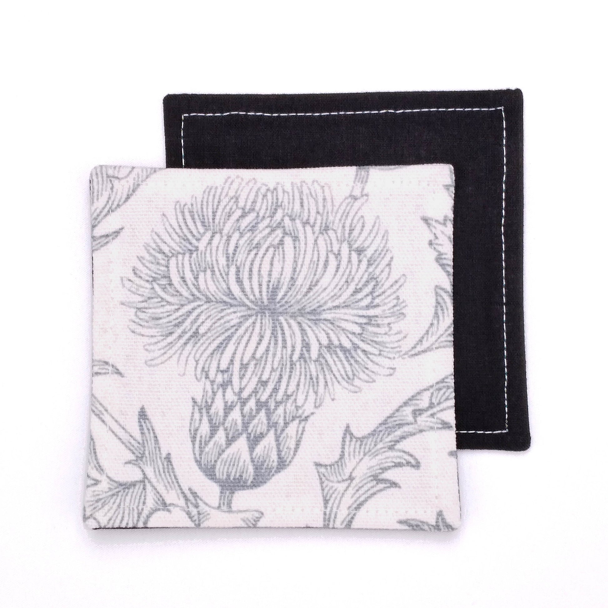 Square coasters with grey thistle design on white background