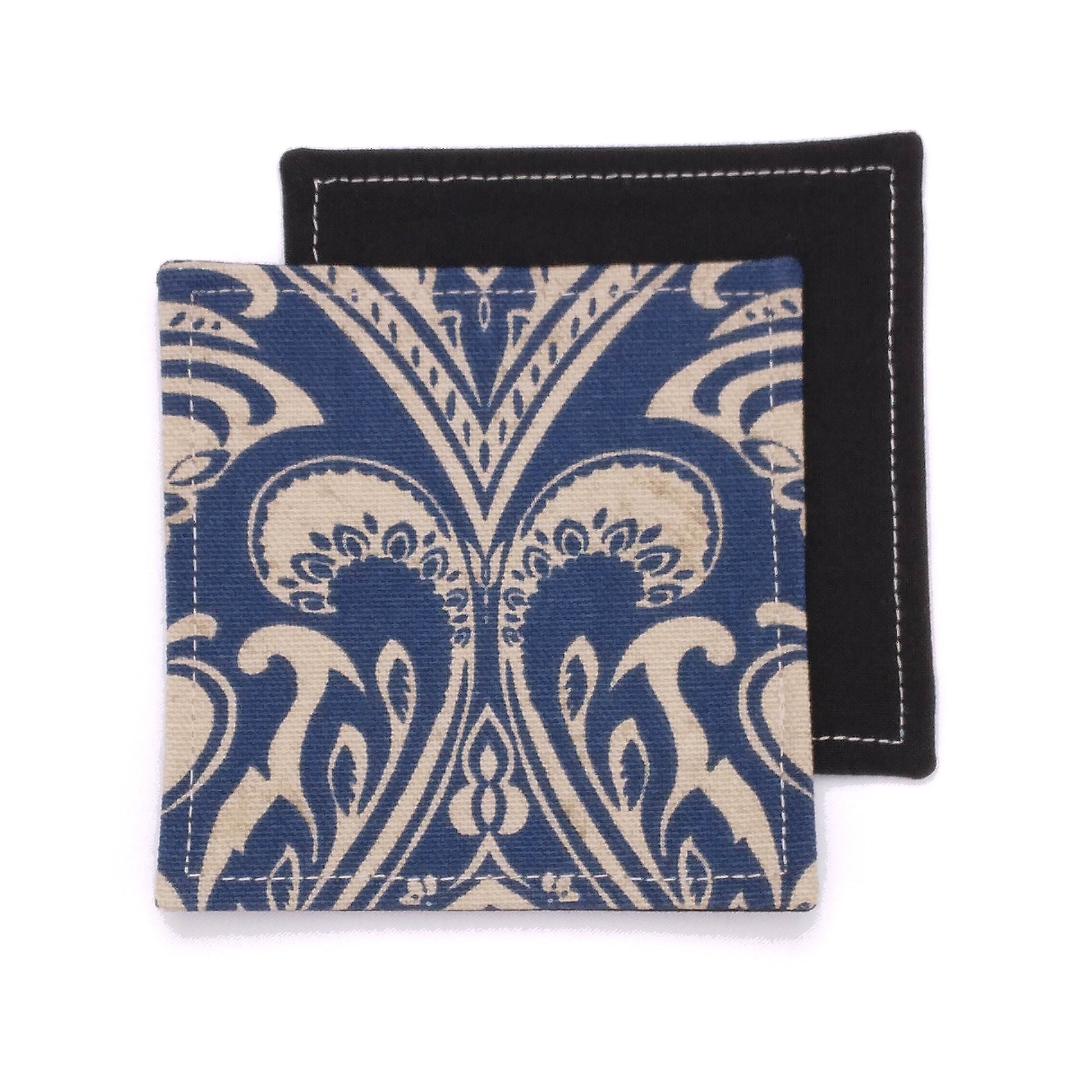 Square coasters with tan damask print on blue background
