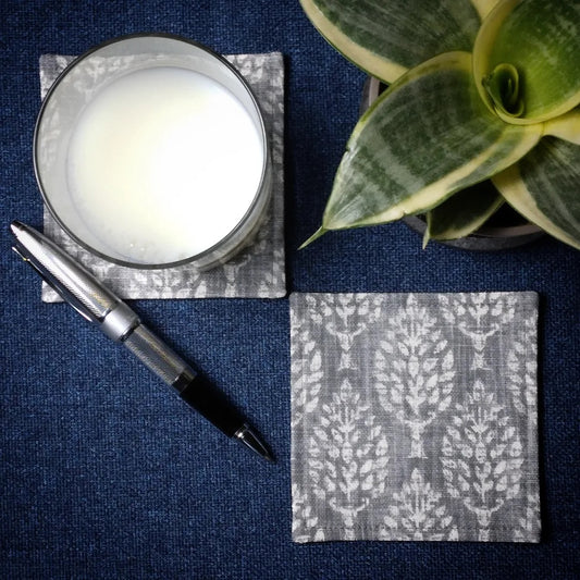 Square coasters with off white poplar trees design on grey background