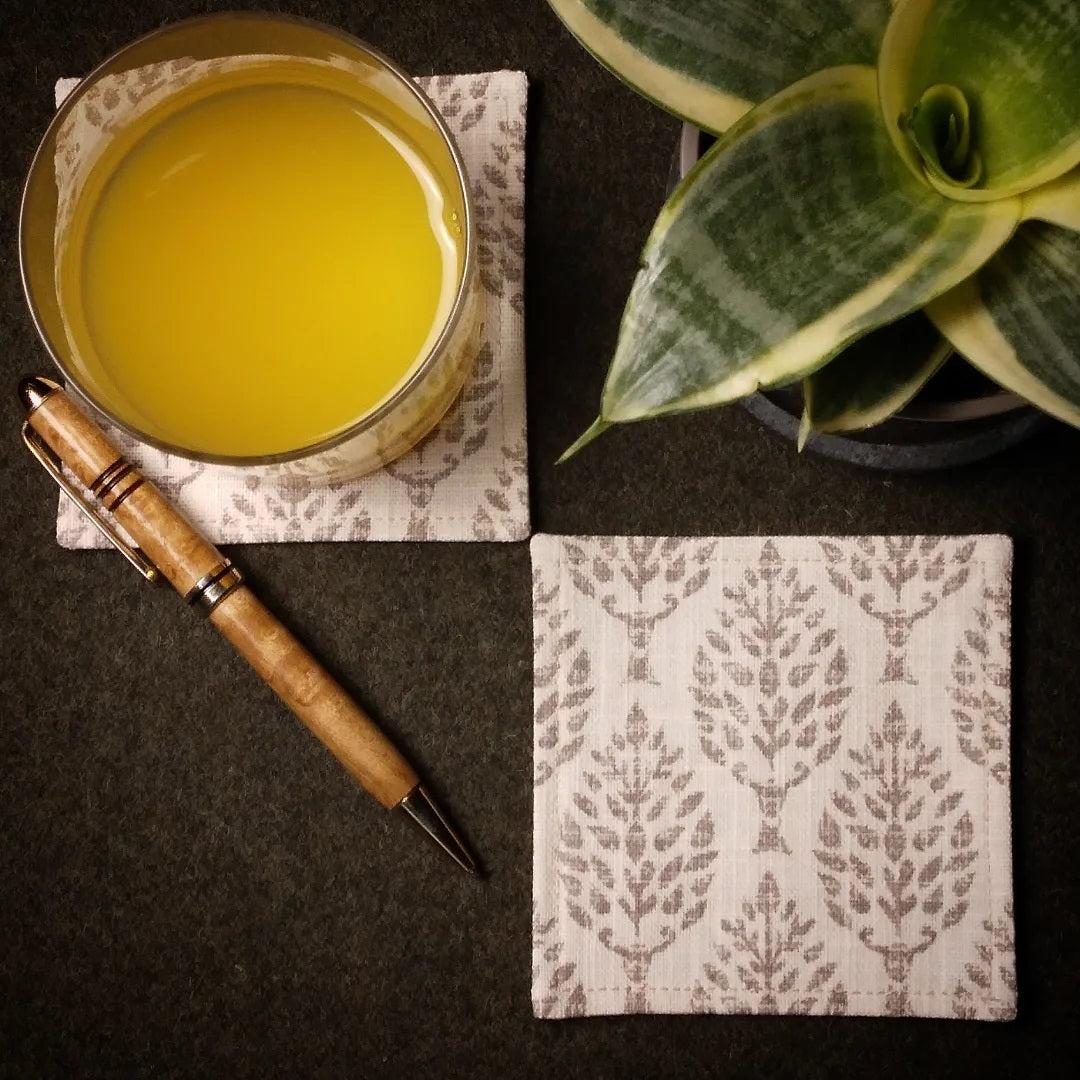 Square coasters with tan poplar trees design on natural colour background