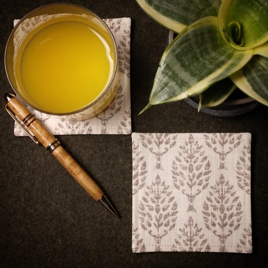 Square coasters with tan poplar trees design on natural colour background