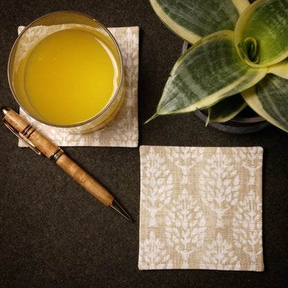 Square coasters with tan poplar trees design on wheat colour background