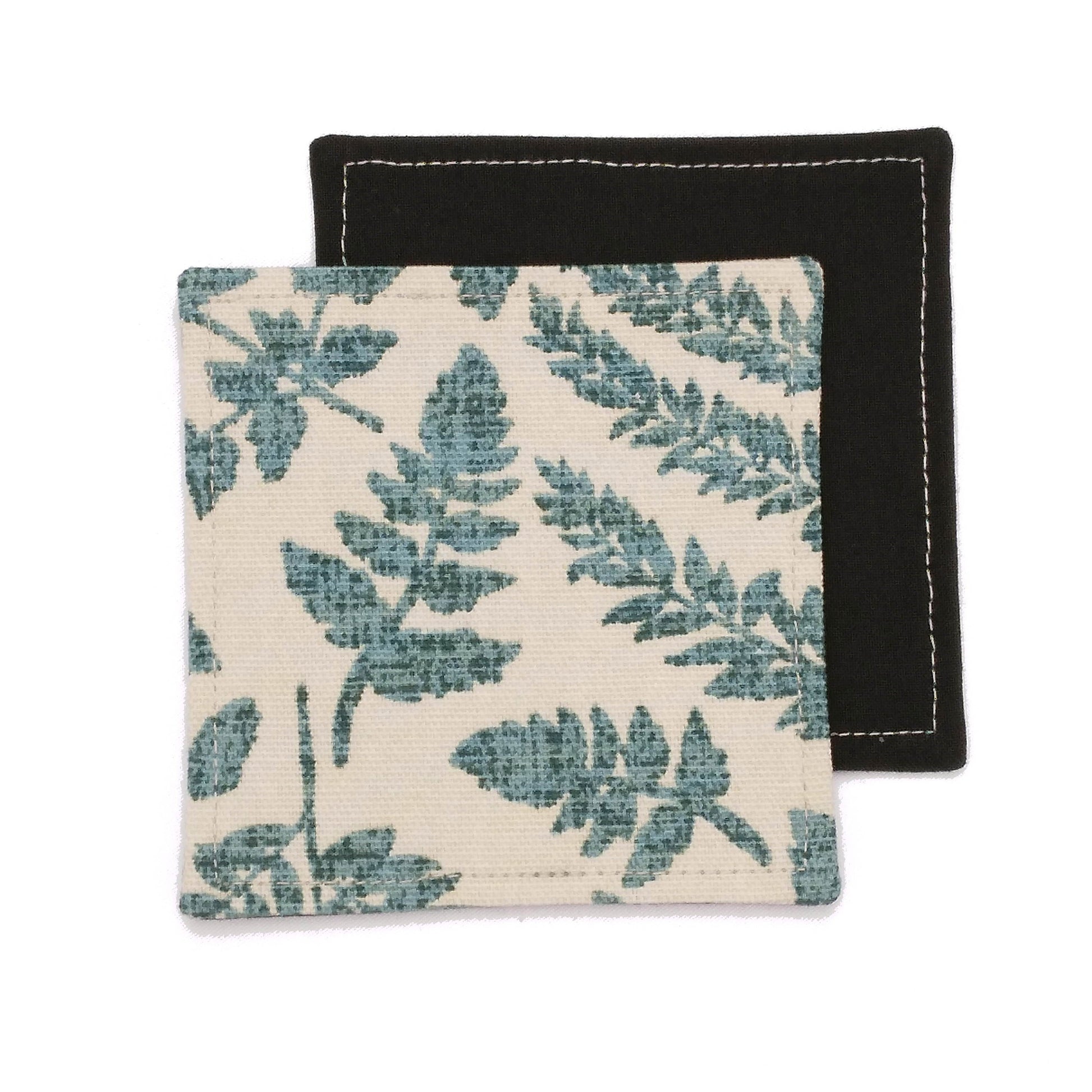 Square coasters with green fern leaves design on beige background