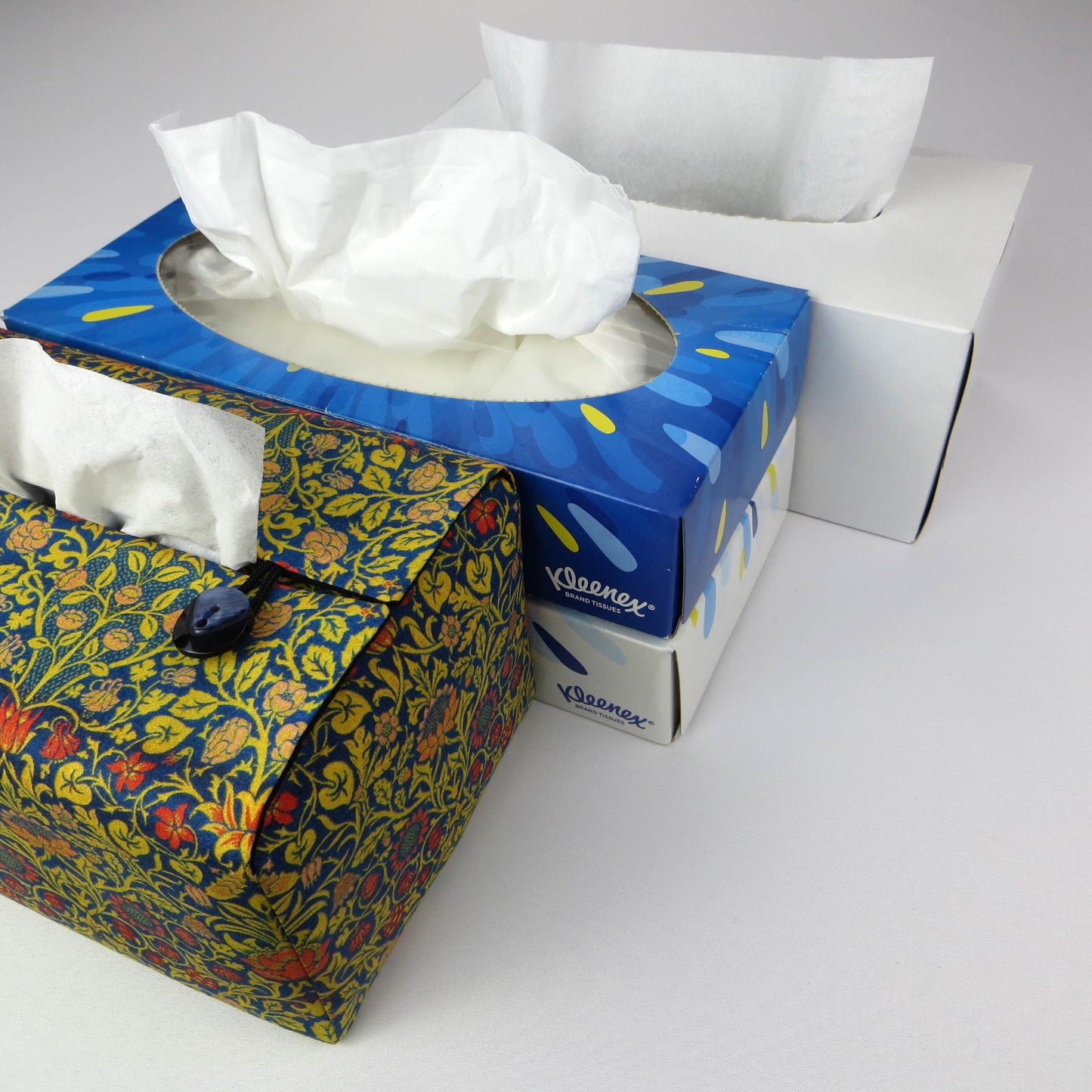 Rectangle tissue box cover with orange flowers and yellow vines design on blue background