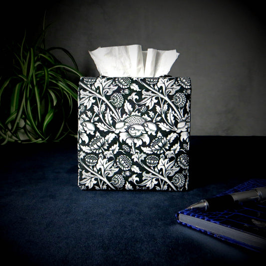 Square tissue box cover with white flowering vine design on black background