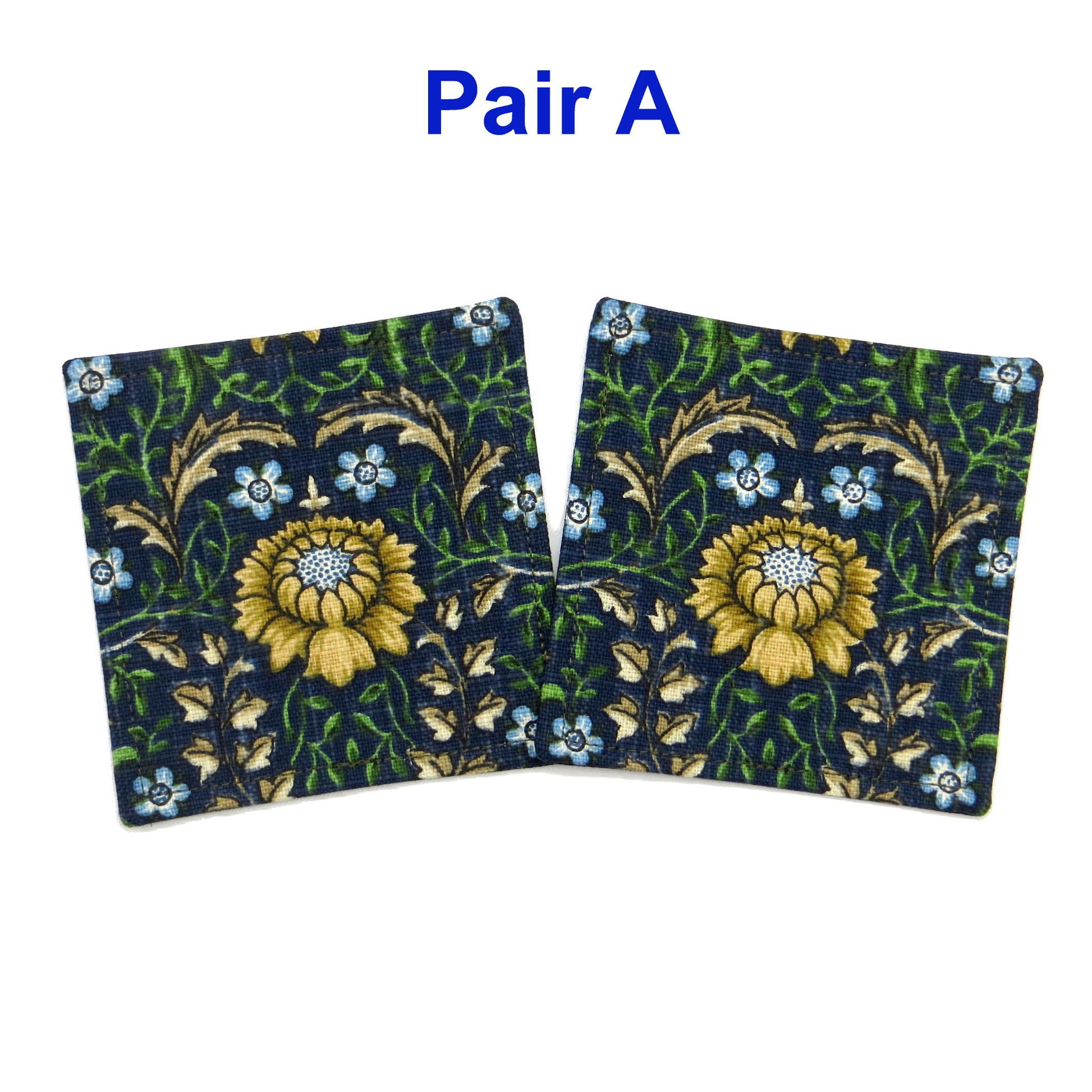 Square coasters with yellow, red, and blue flowers with green vines on blue background