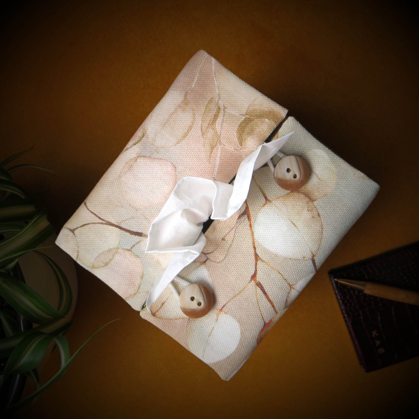 Printed cotton square tissue box with lunaria leaf design on brown background