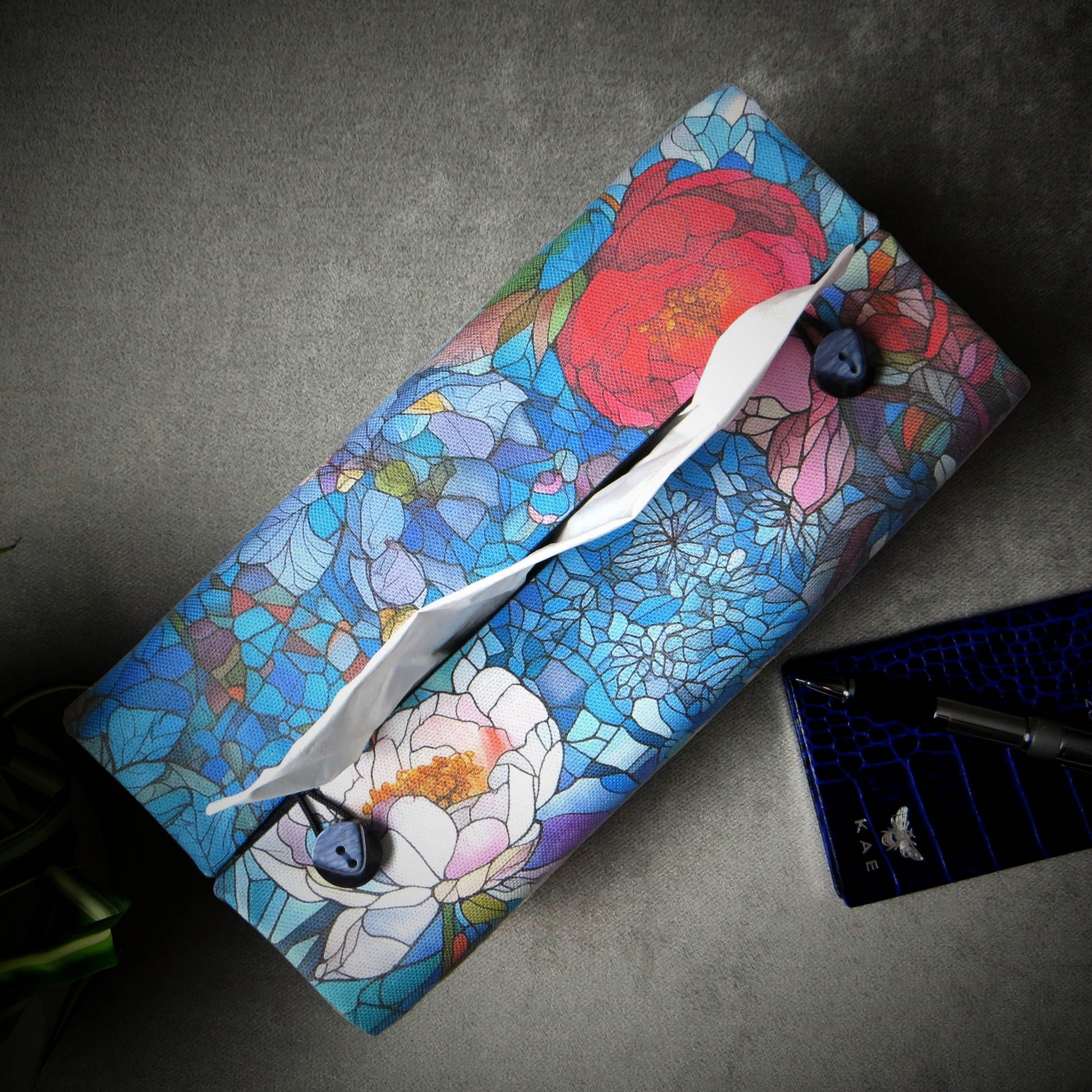 Rectangular tissue box cover with floral garden stained glass design on blue toned background