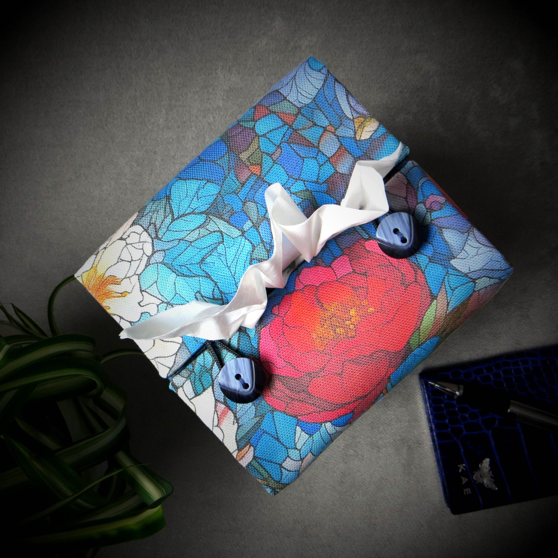 Square tissue box cover with floral garden stained glass design on blue toned background