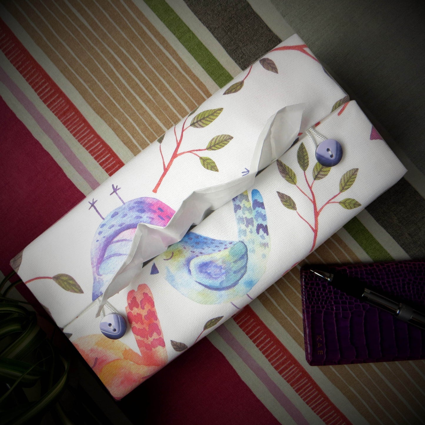 Cotton rectangle tissue box cover with watercolour style blue, purple, and orange sleeping birds on white background