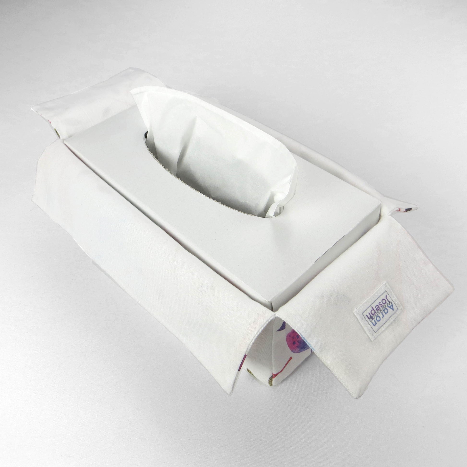 Cotton rectangle tissue box cover with watercolour style blue, purple, and orange sleeping birds on white background