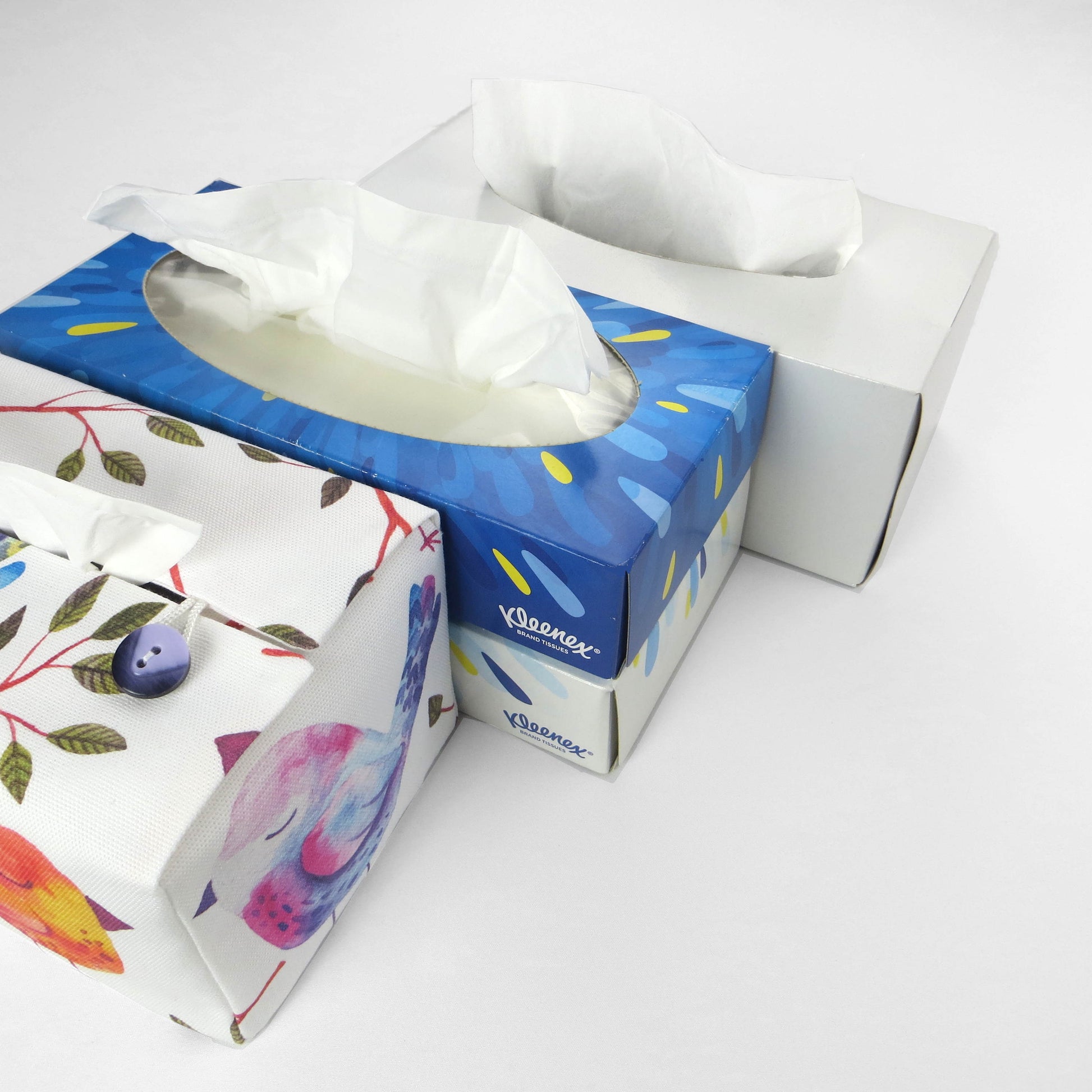 Cotton rectangle tissue box cover with watercolour style blue, purple, and orange sleeping birds on white background