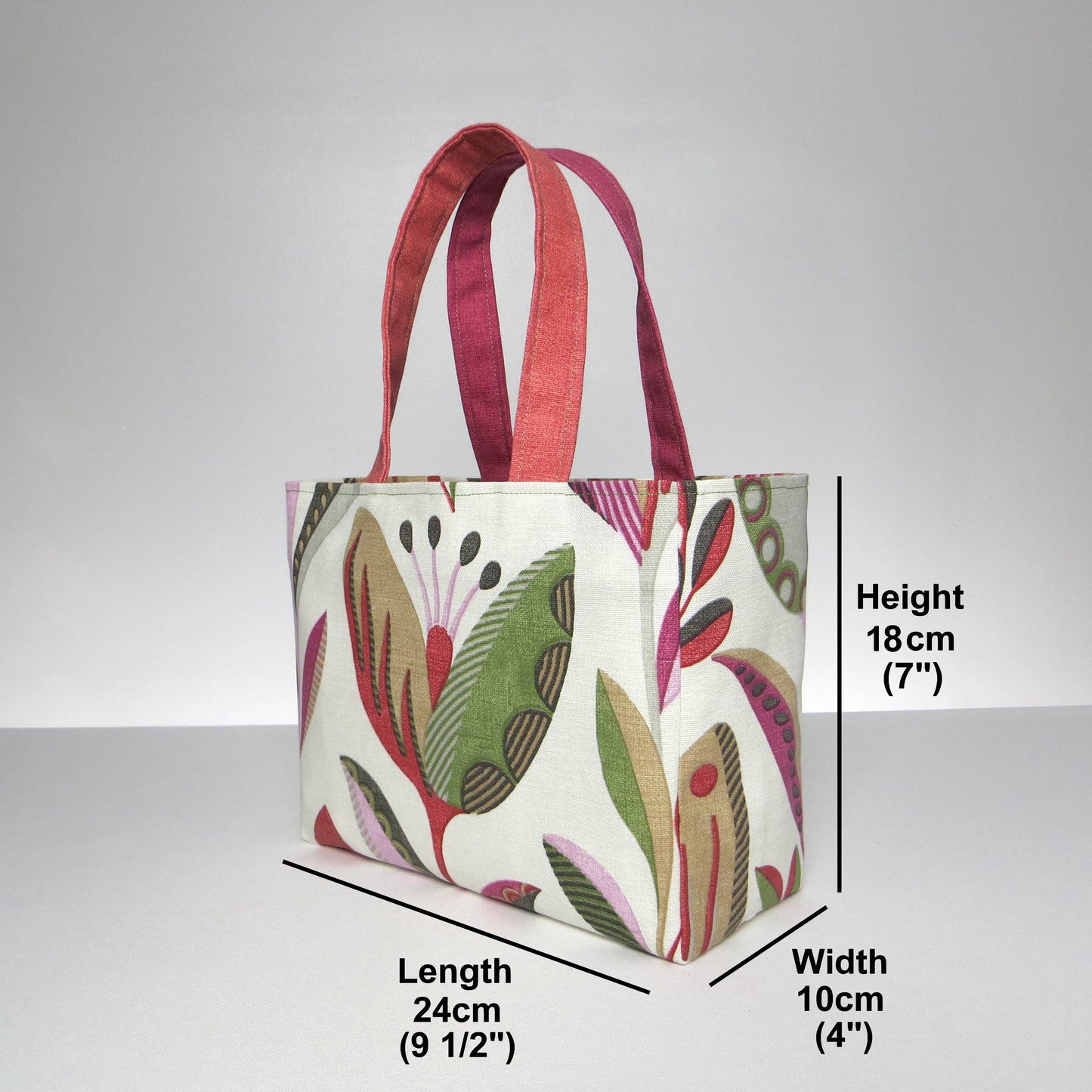 Small cotton tote bag with shades of moss green, raspberry pink, soft grey, and rhubarb red tulips on off-white background