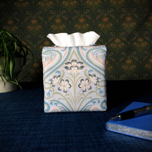 Square tissue box cover with charcoal grey and white flowers with blue, green and taupe Victorian embellishment on blue-grey background