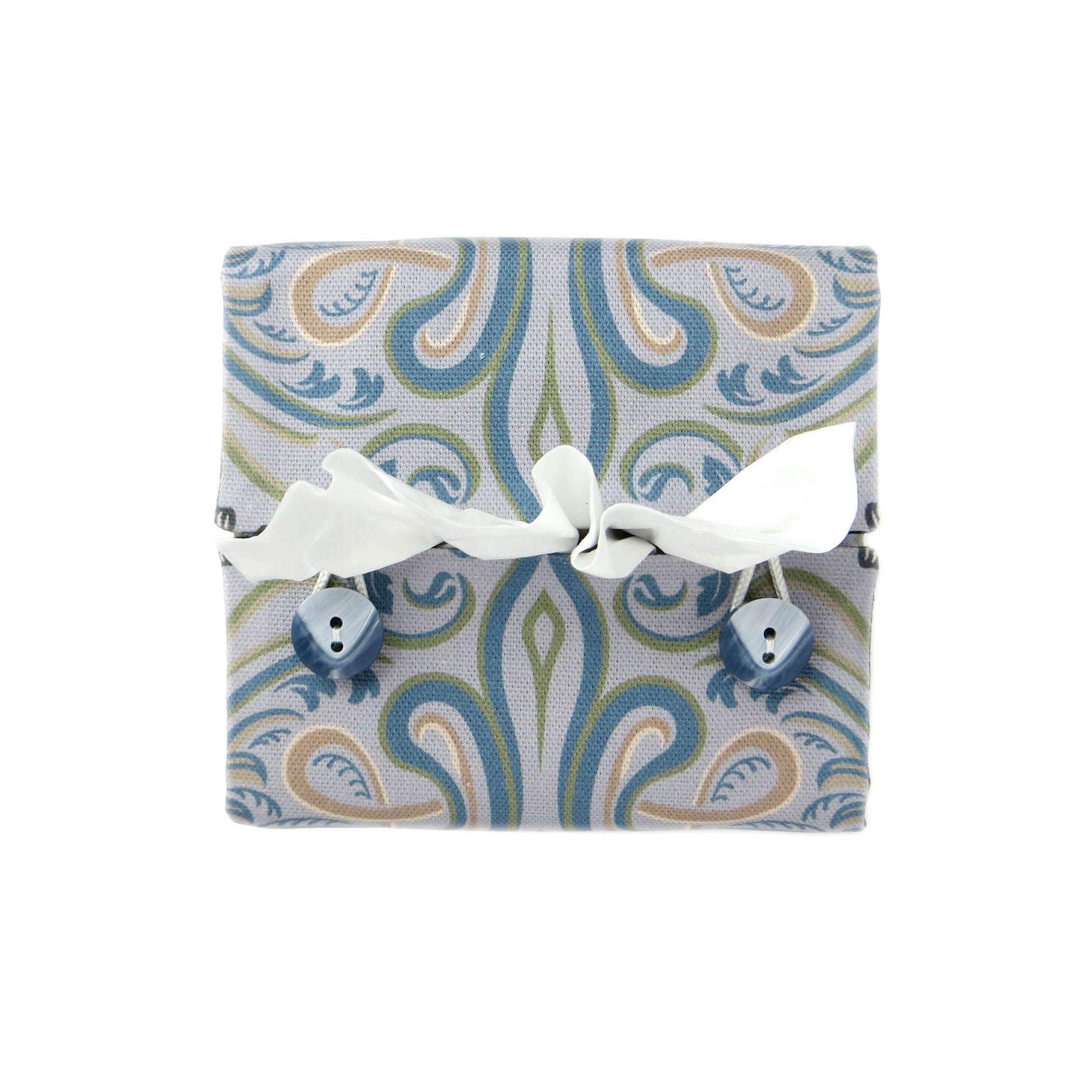 Square tissue box cover with charcoal grey and white flowers with blue, green and taupe Victorian embellishment on blue-grey background